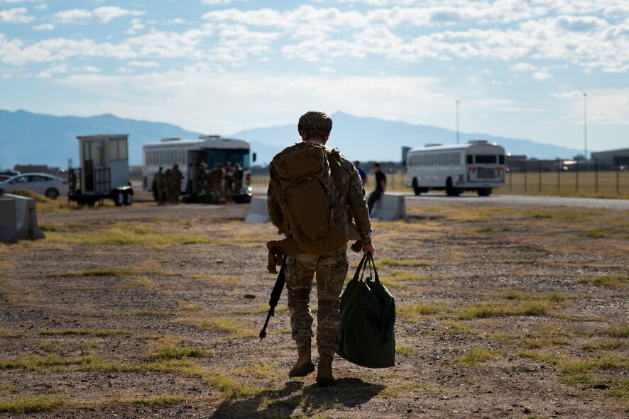 Person carrying gear walks.