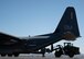 Airplane being unloaded with a forklift on the flight line.