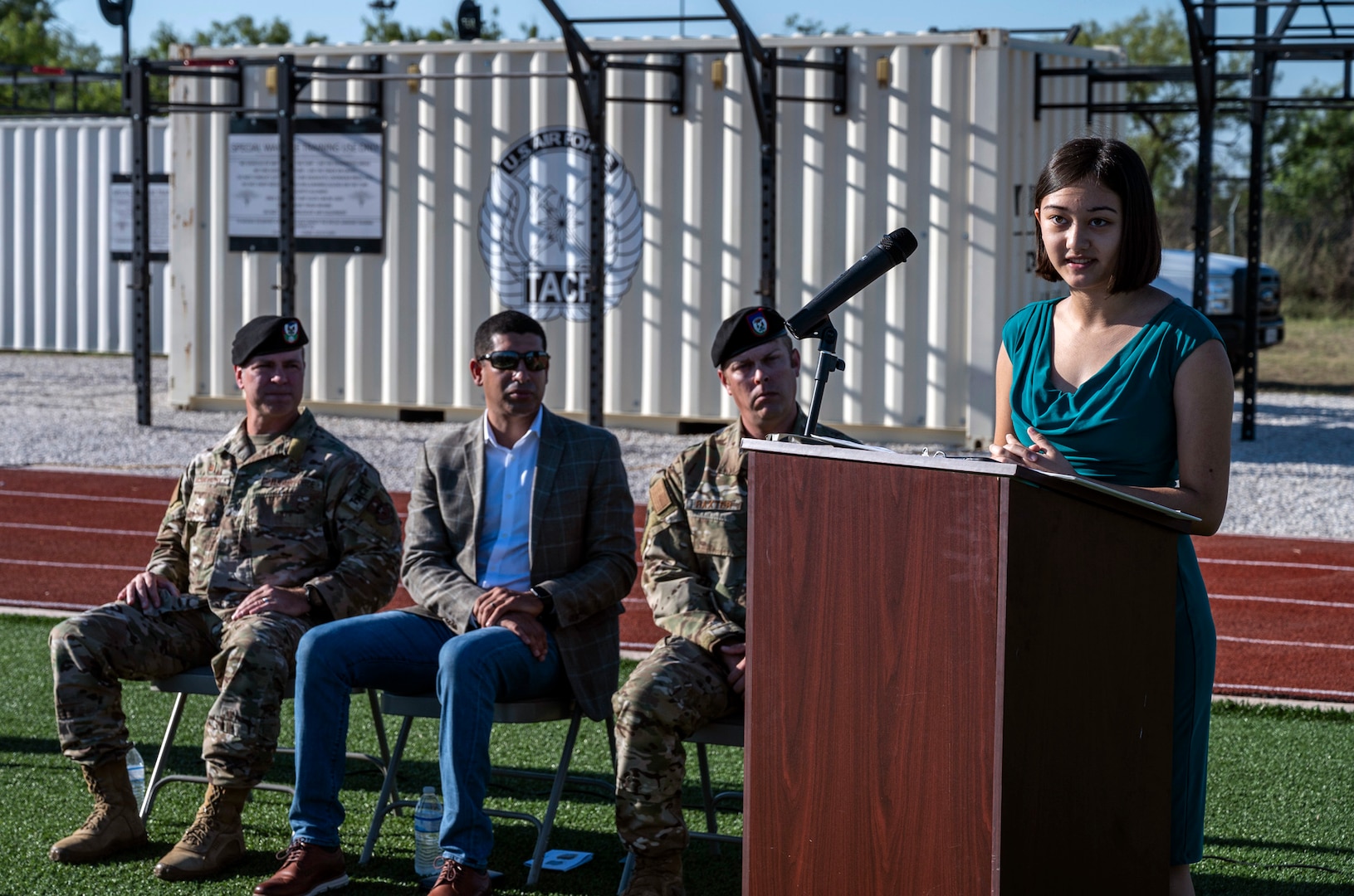female military dependent standing at podium giving a speech