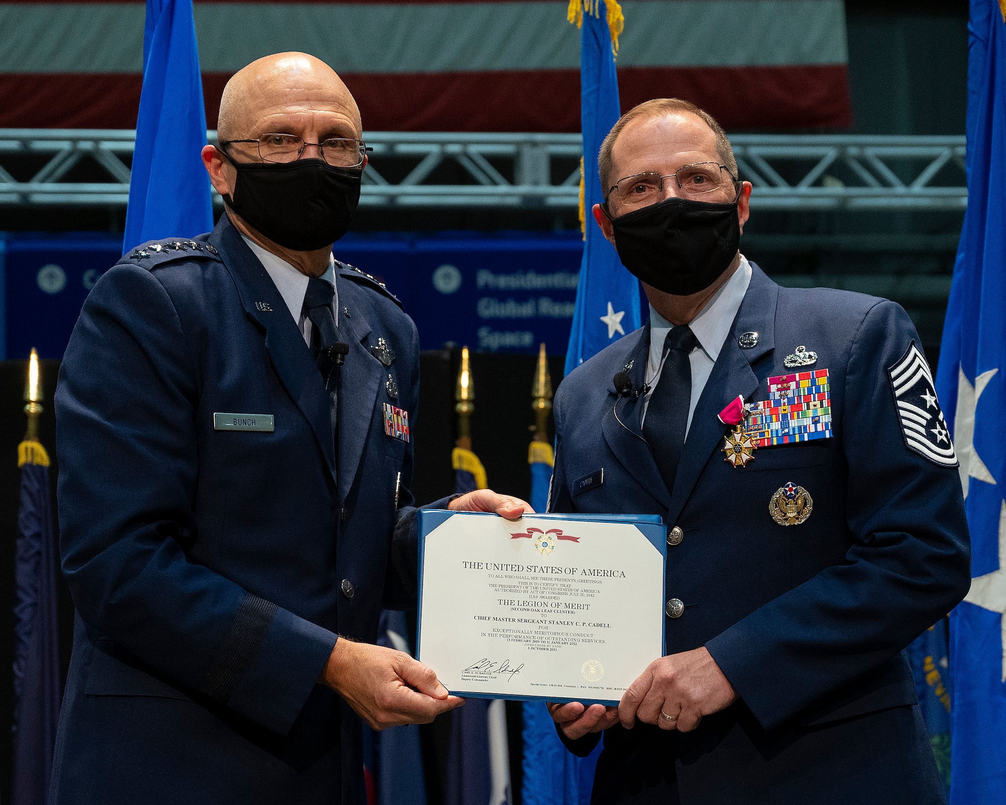 Gen. Arnold Bunch Jr. (left), commander of Air Force Materiel Command, presents the Legion of Merit to Chief Master Sgt. Stanley Cadell during the AFMC command chief’s retirement ceremony Oct. 1, 2021,  in the National Museum of the U.S. Air Force at Wright-Patterson Air Force Base, Ohio. (U.S. Air Force photo by R.J. Oriez)