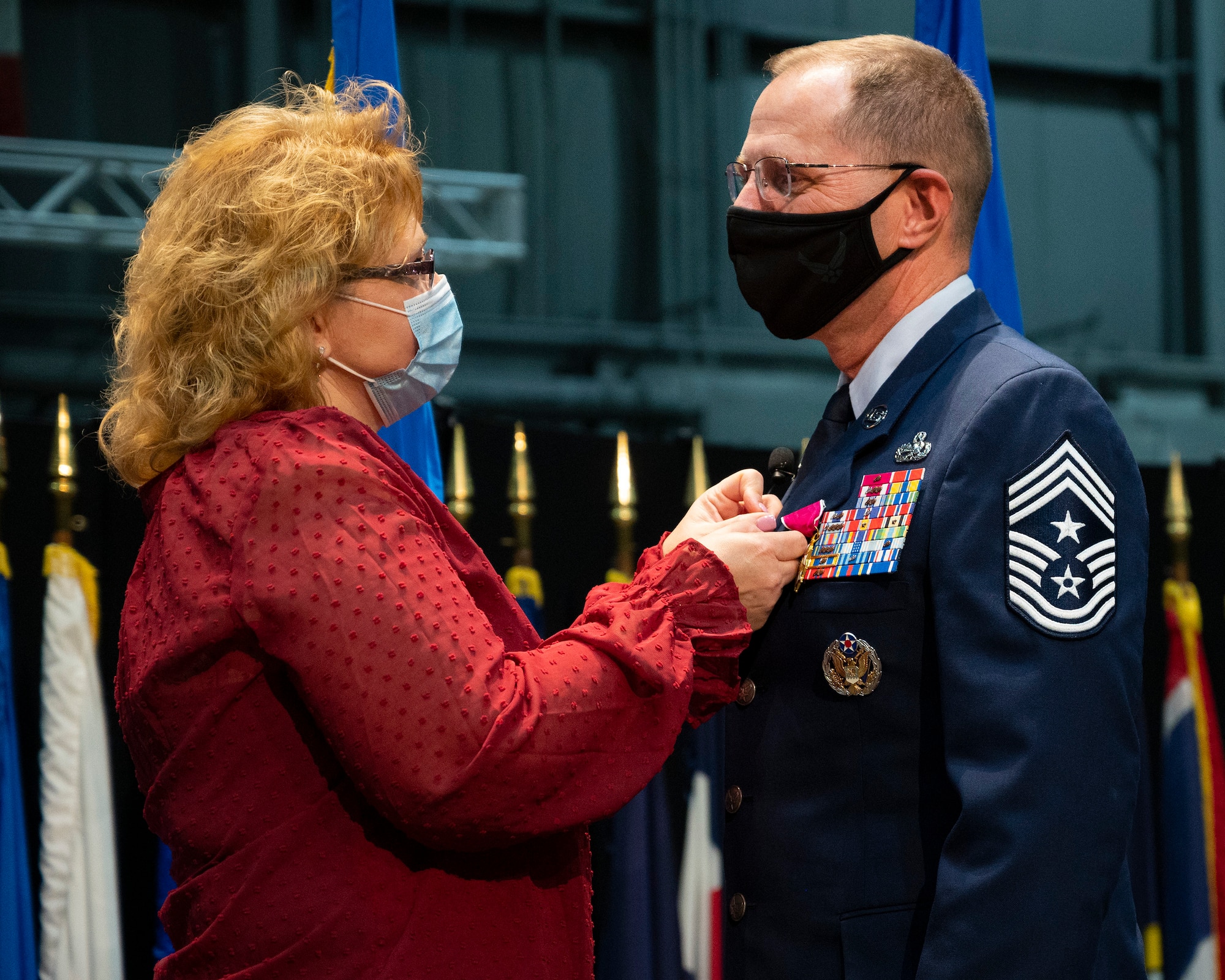 Chief Master Sgt. Stanley Cadell, Air Force Materiel Command command chief, receives his retirement pin from wife, Rhonda, during a farewell ceremony Oct. 1, 2021, at Wright-Patterson Air Force Base. Cadell retired after 30 years of service. (U.S. Air Force photo by R.J. Oriez)