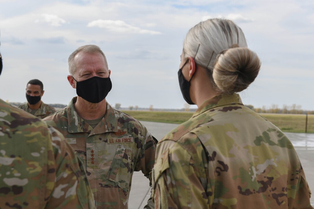 U.S. Air Force Gen. Mark Kelly, commander of Air Combat Command, talks with 319th Civil Engineer Squadron firefighter Senior Airman Baylee Govier after a demonstration by the base fire department on Grand Forks Air Force Base, N.D., Oct. 7, 2021. During his visit to Grand Forks AFB, Kelly interacted with Airmen from across the installation to learn about their role in the Air Force mission and discuss ACC objectives. (U.S. Air Force photo by Airman 1st Class Ashley Richards)