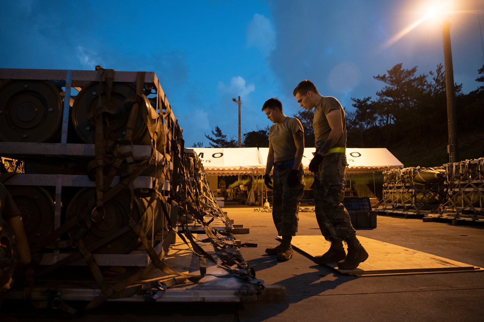 Two 18th MUNS Airmen build pallets.