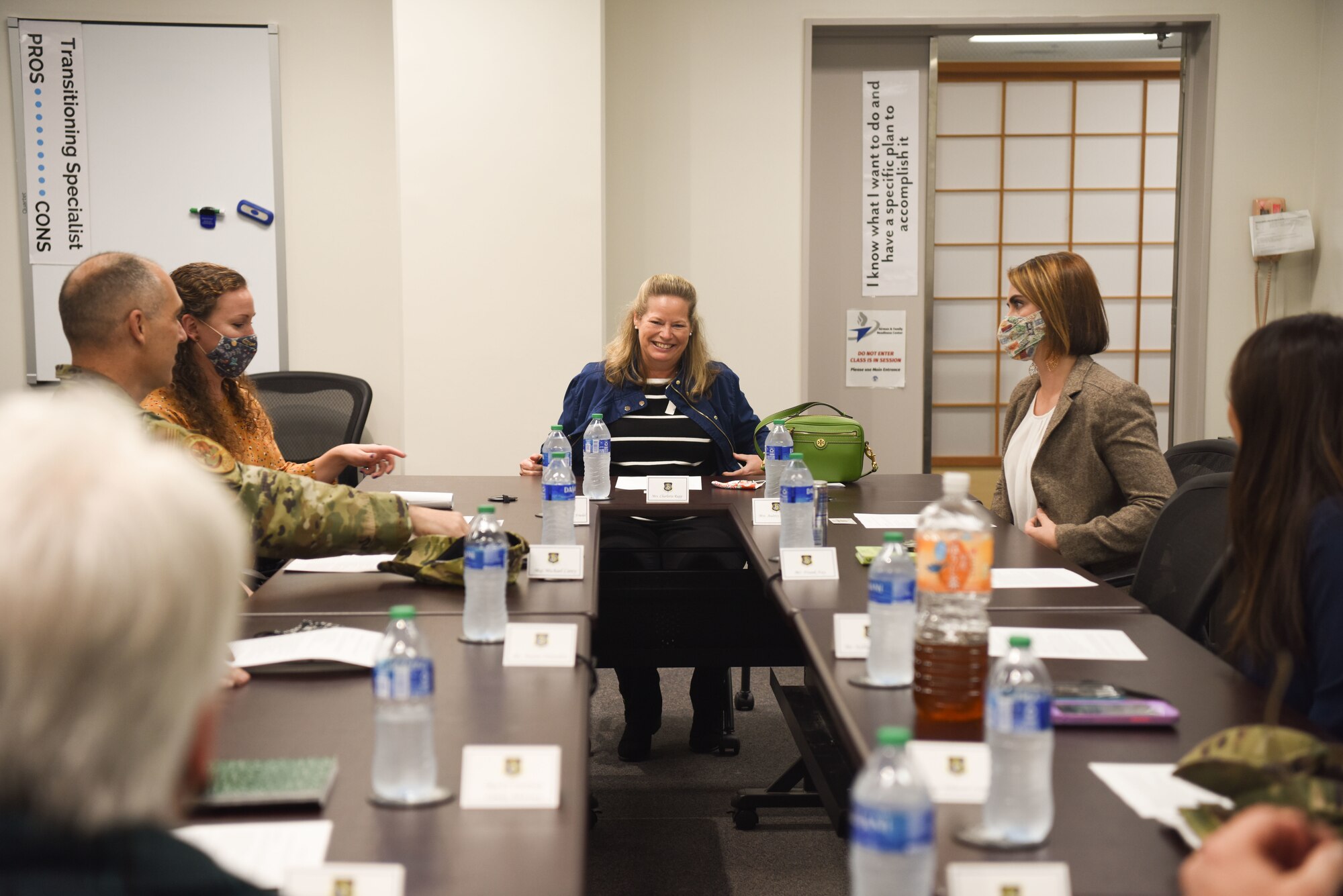 people sit around a conference table