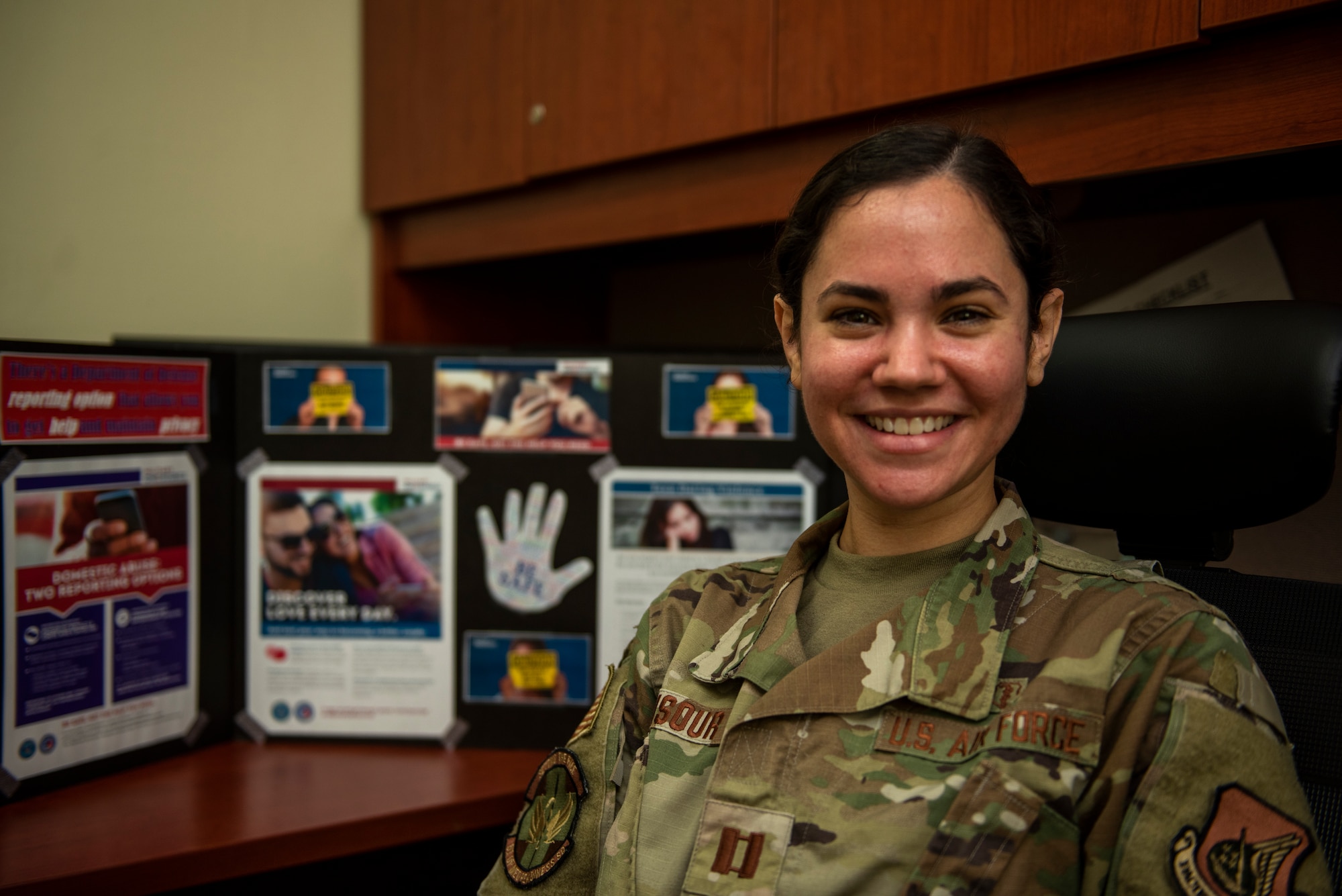 Capt. Amanda Mansour, 51st Operational Medical Readiness Squadron family advocacy officer, displays educational material for Domestic Violence Prevention Awareness Month