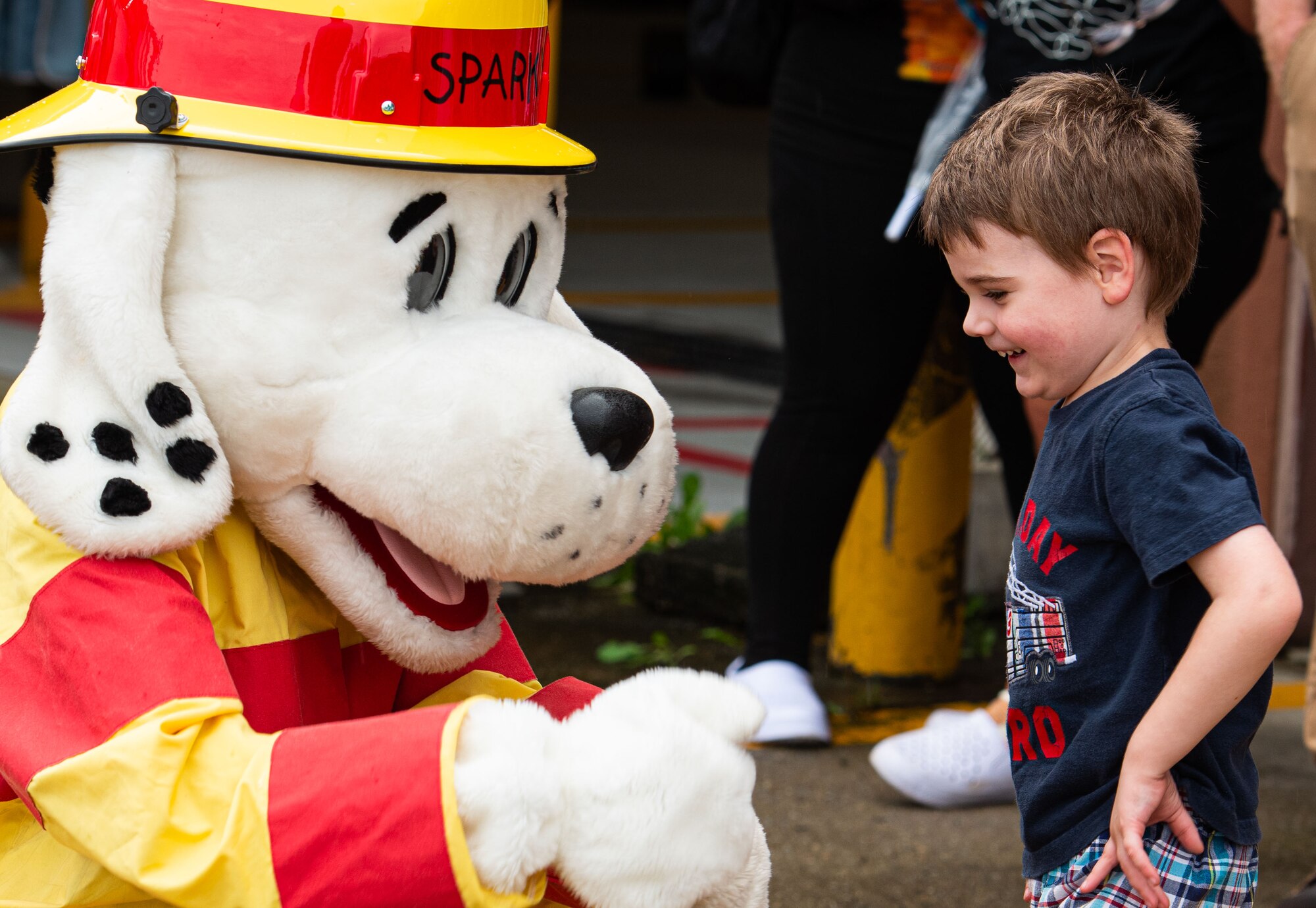 Sparky, the 51st Fighter Wing Fire Department mascot, greets a child during a Fire Prevention Week open house event at Osan Air Base, Republic of Korea, Oct. 9, 2021.
