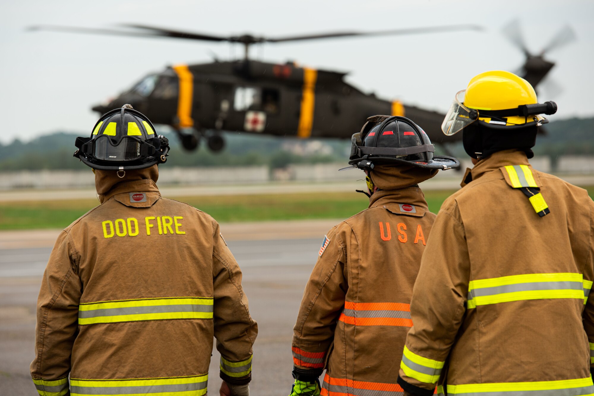 Airmen from the 51st Civil Engineer Squadron prepare for a simulated helicopter extraction during a Fire Prevention Week open house event at Osan Air Base, Republic of Korea, Oct. 9, 2021.
