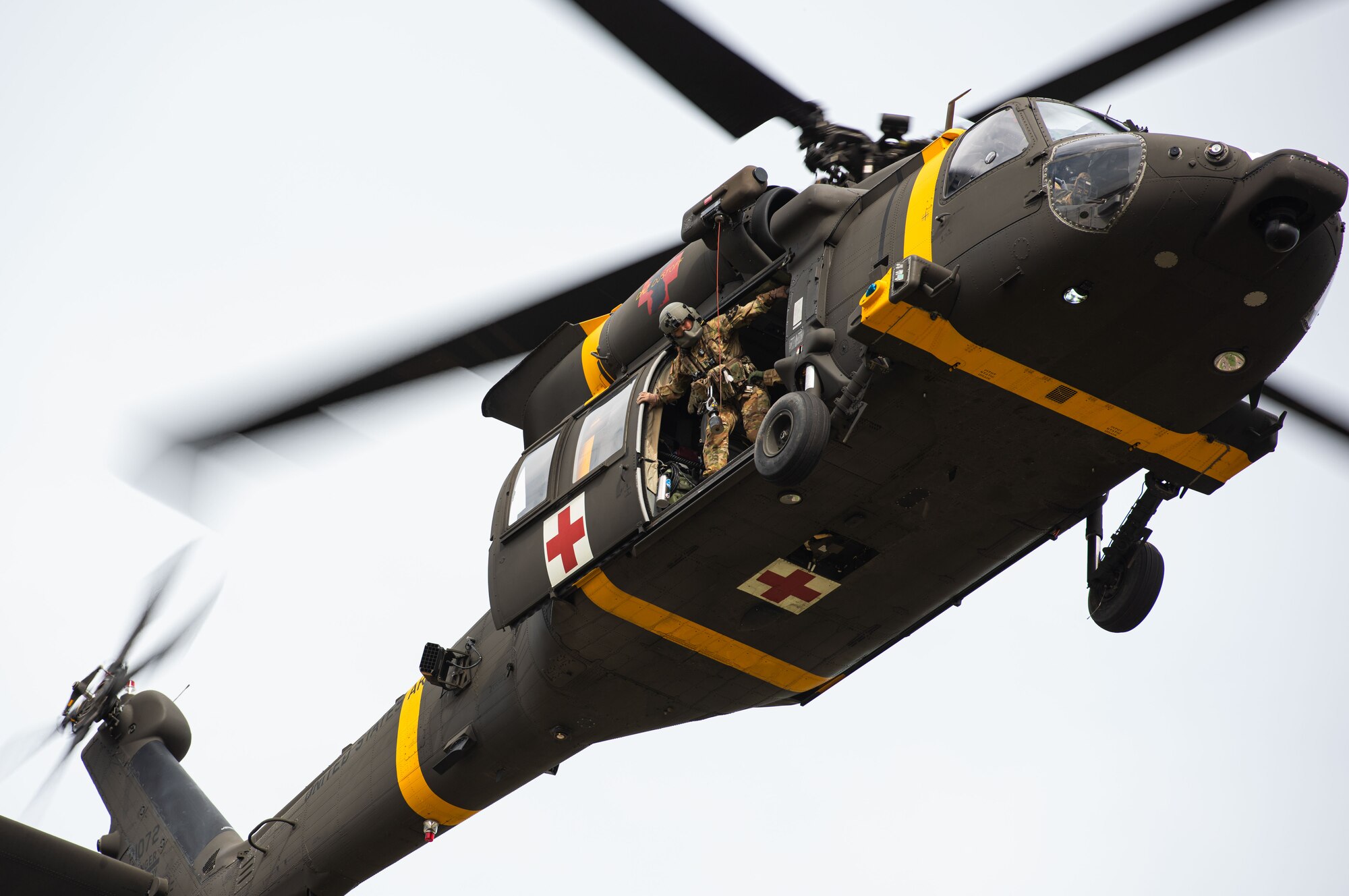 Staff Sgt. Jinsol Kim, Charlie Company 3-2D Aviation Regiment flight paramedic, prepares to perform a UH-60Q Black Hawk helicopter rescue during a Fire Prevention Week open house rescue demonstration at Osan Air Base, Republic of Korea, Oct. 9, 2021.