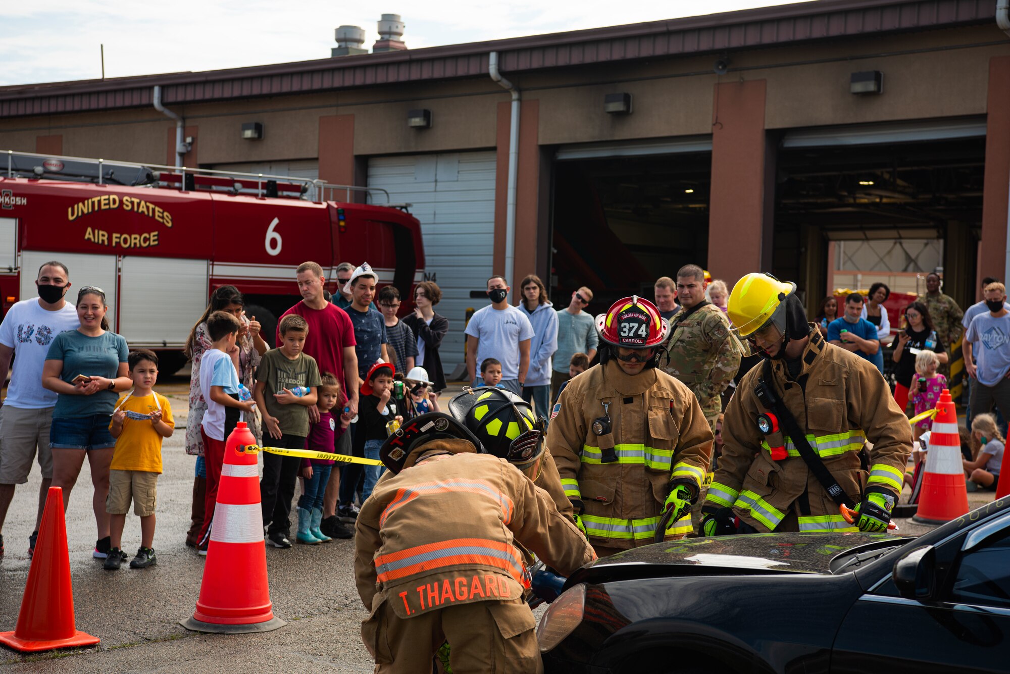 Military service members and their dependents watch a UH-60Q Black Hawk helicopter rescue demonstration during a Fire Prevention Week open house at Osan Air Base, Republic of Korea, Oct. 9, 2021.