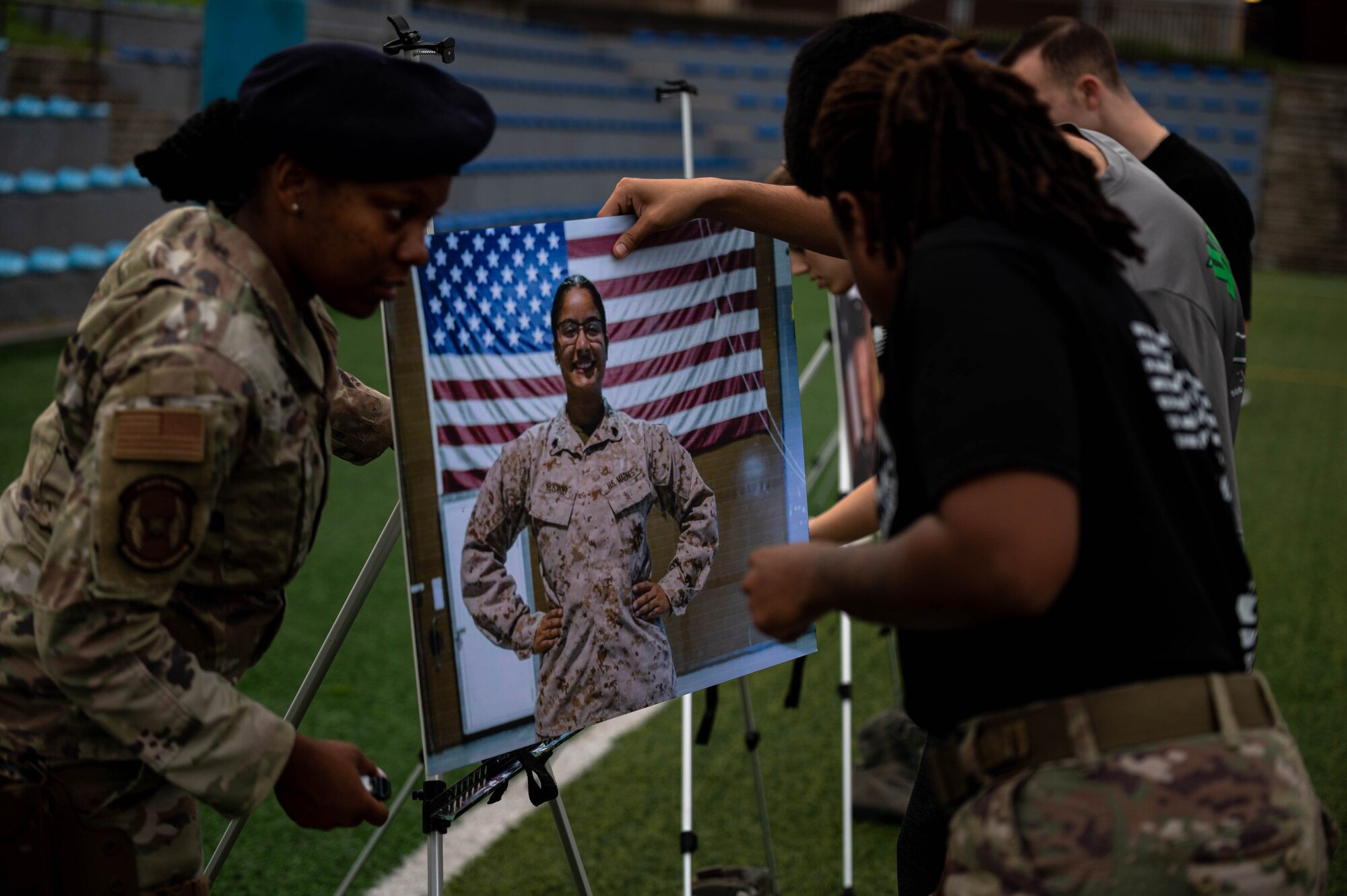 51st Security Forces Squadron members place the picture of U.S. Marine Corps Sgt. Johanny Rosario Pichardo during a memorial ruck march