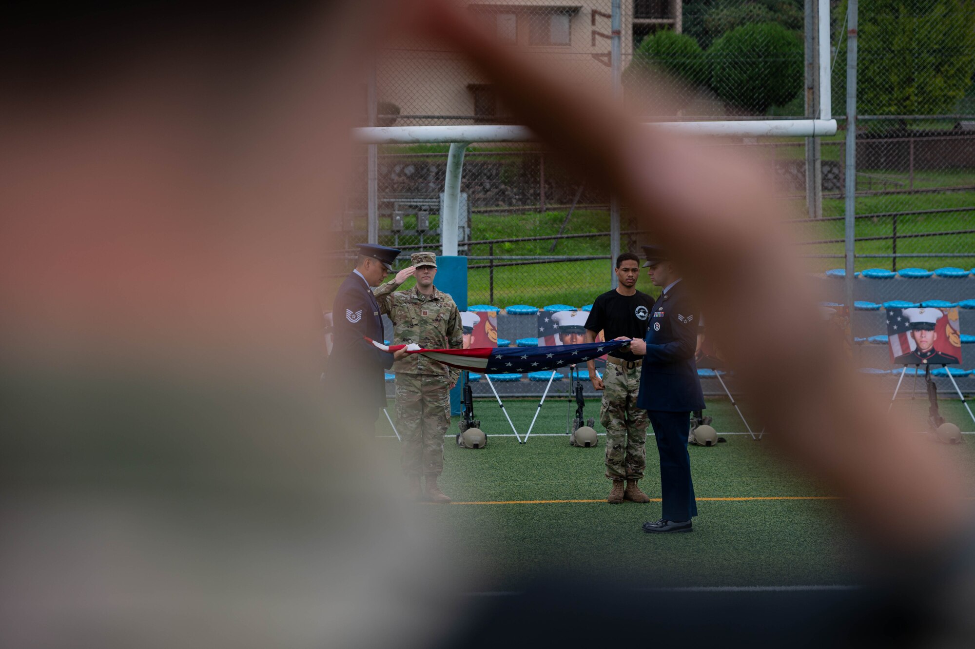 51st Fighter Wing honor guardsmen, fold a U.S. flag before a memorial ruck march