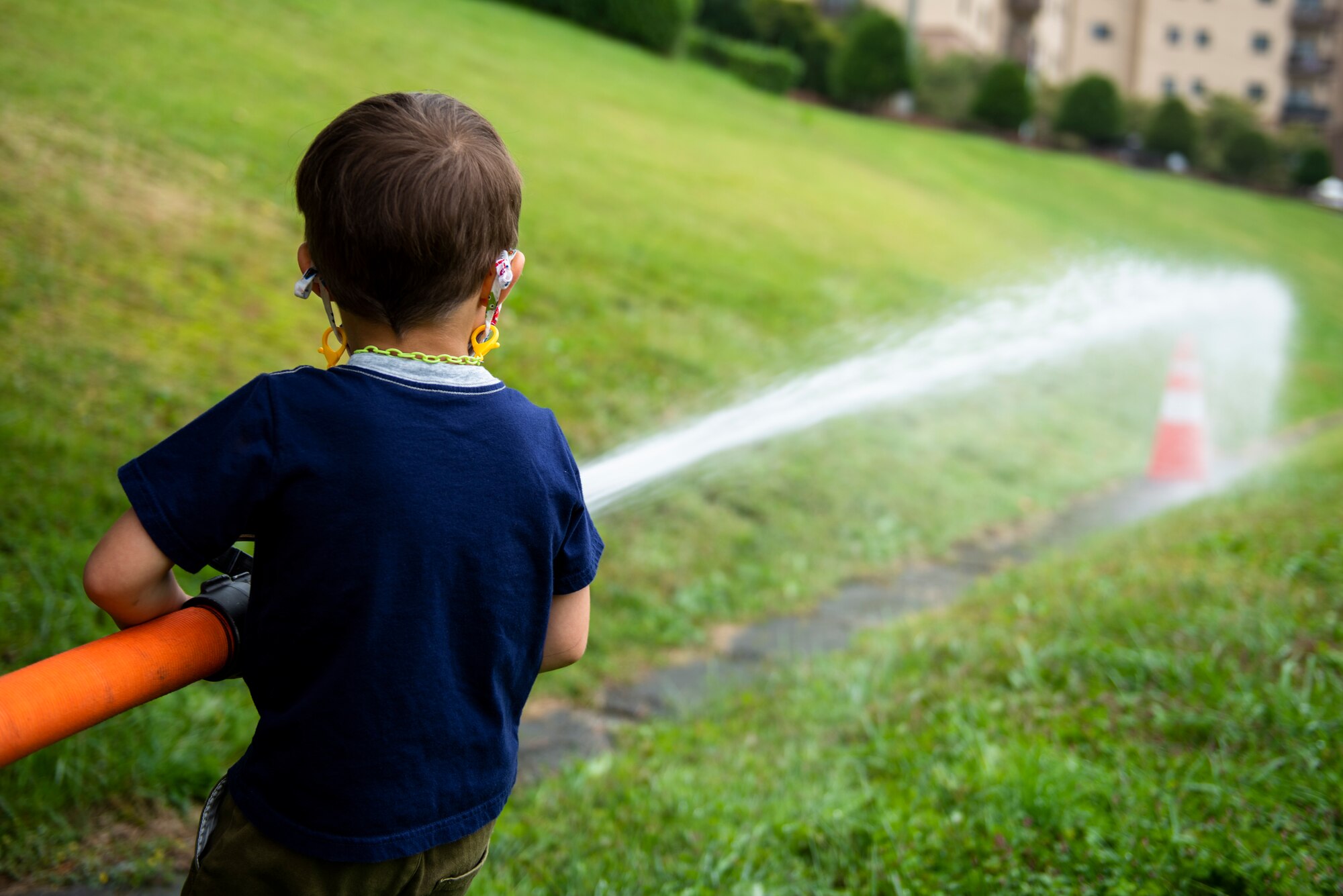 A child attendee uses a fire hose during the Fire Prevention Week’s Kids Showcase