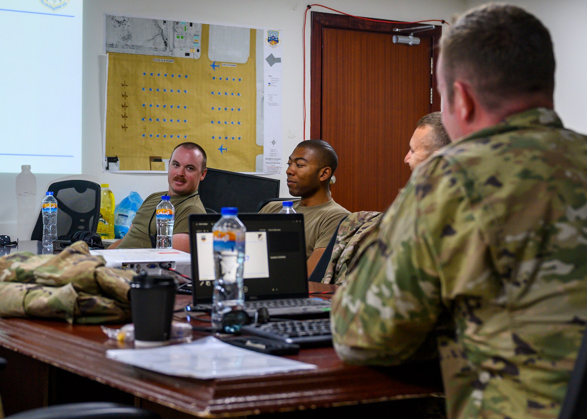 Members of the 332nd Air Expeditionary Wing ask questions of Master Sgt. Andrew Linke, 121st Expeditionary Fighter Squadron hot-pit certifier, during the classroom portion of hot pit refueling training at Prince Sultan Air Base, Kingdom of Saudi Arabia, Sept. 24, 2021. Maintenance crews assigned to the 332nd and 378th AEWs conducted a hot pit refueling training exchange over the course of several weeks, increasing their agile combat employment capabilities by ensuring both F-16 Fighting Falcons and F-15E Strike Eagles can be refueled by each wing. (U.S. Air Force photo by Senior Airman Samuel Earick)