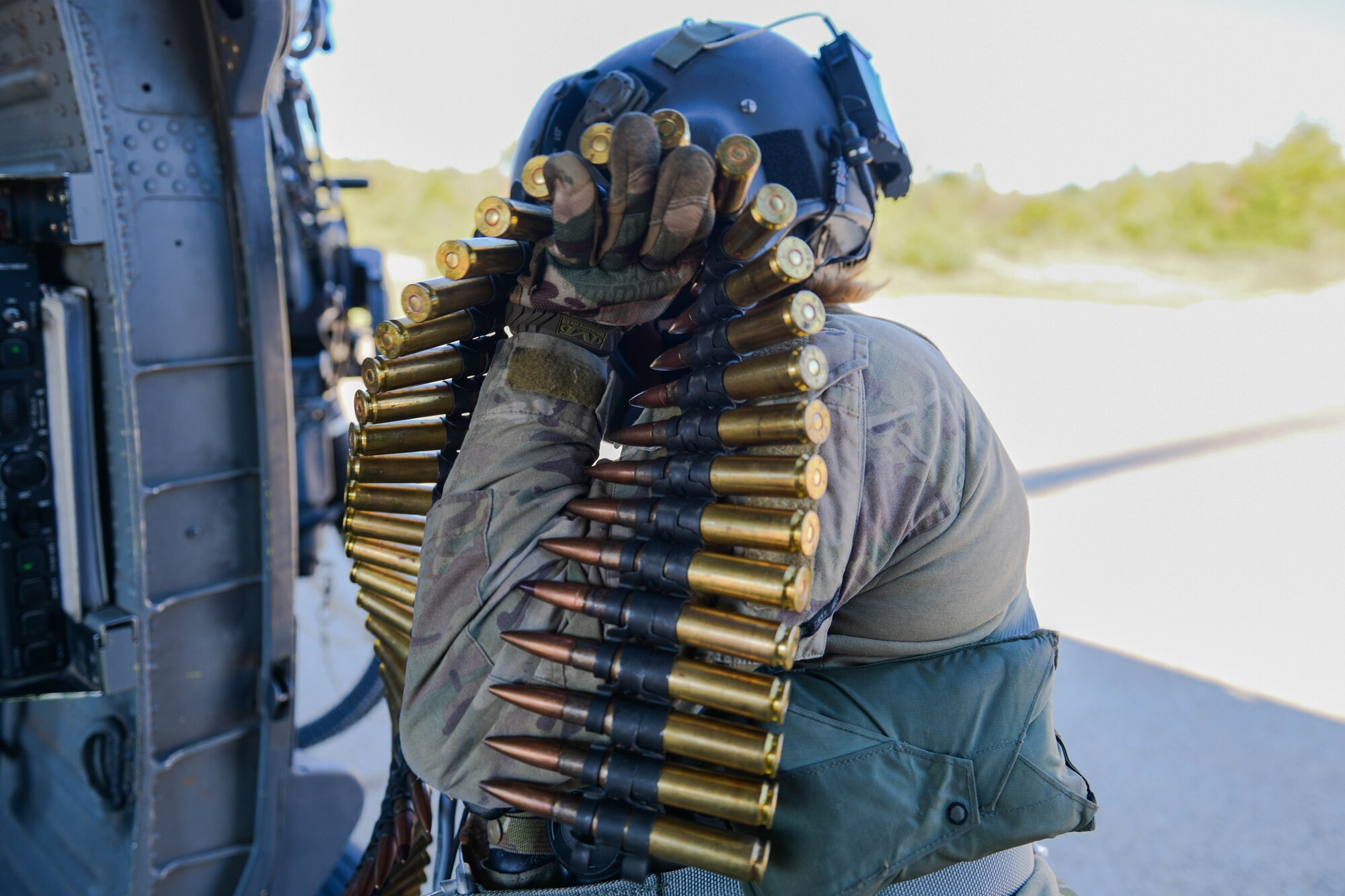 U.S. Air Force Staff Sgt. Kinga Hudson, 56th Rescue Squadron special missions aviator, loads ammunition onto an HH-60G Pave Hawk in Croatia, Sept. 23, 2021. Three crew members completed .50 caliber and mini gun training during the sortie. (U.S. Air Force photo by Senior Airman Brooke Moeder)