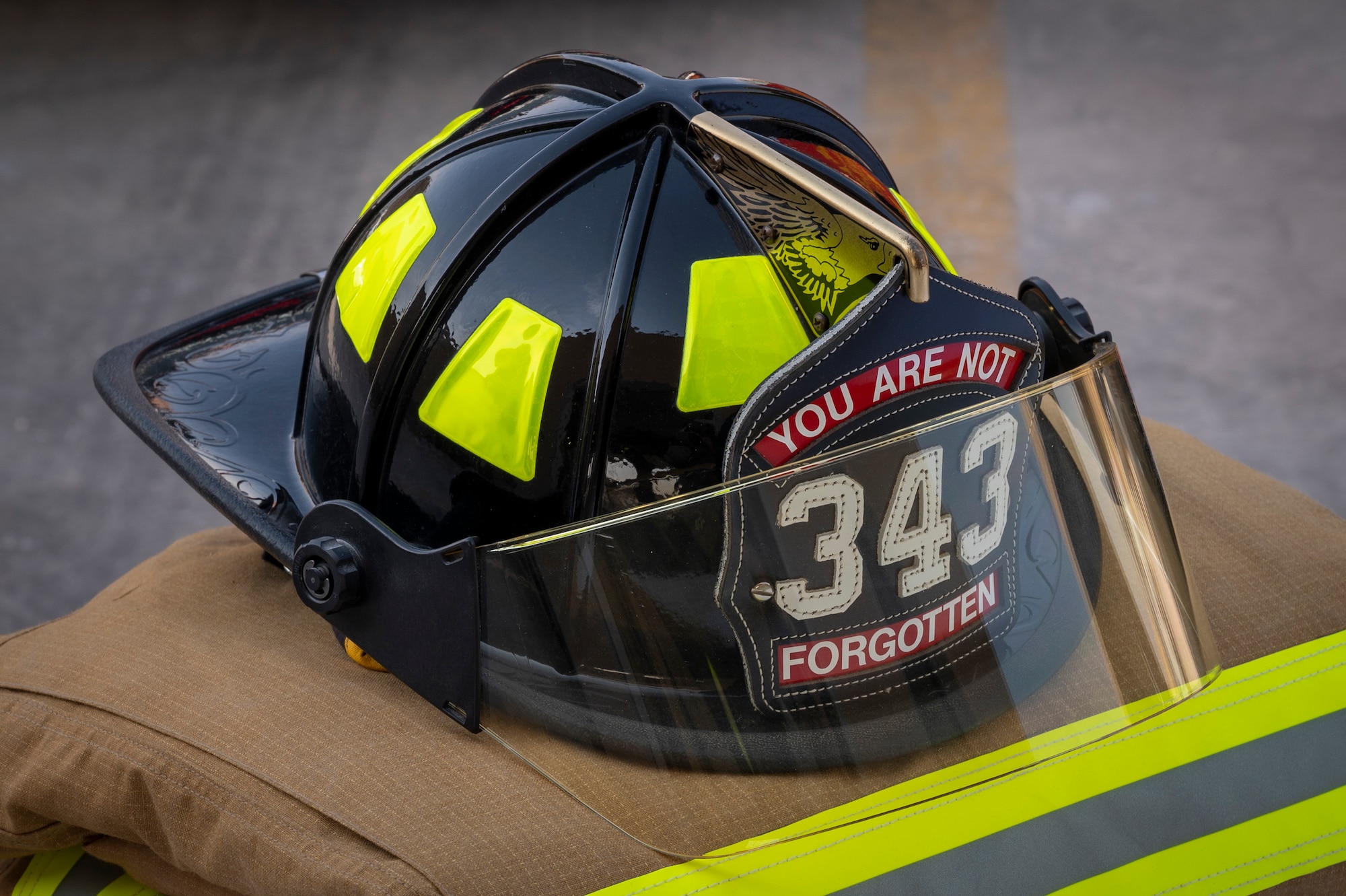A fire helmet on top of a fire suit is displayed during a Fire Prevention Week proclamation signing Oct. 5, 2021, at Al Udeid Air Base, Qatar.
