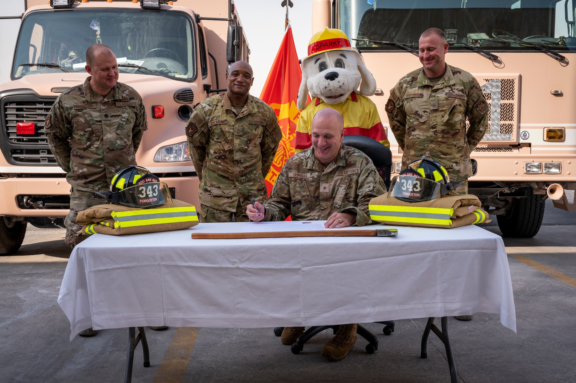 Brig. Gen. Gerald Donohue, 379th Air Expeditionary Wing commander, signs the Fire Prevention Week proclamation outside the 379th Expeditionary Civil Engineer Squadron Oct. 5, 2021, at Al Udeid Air Base, Qatar.