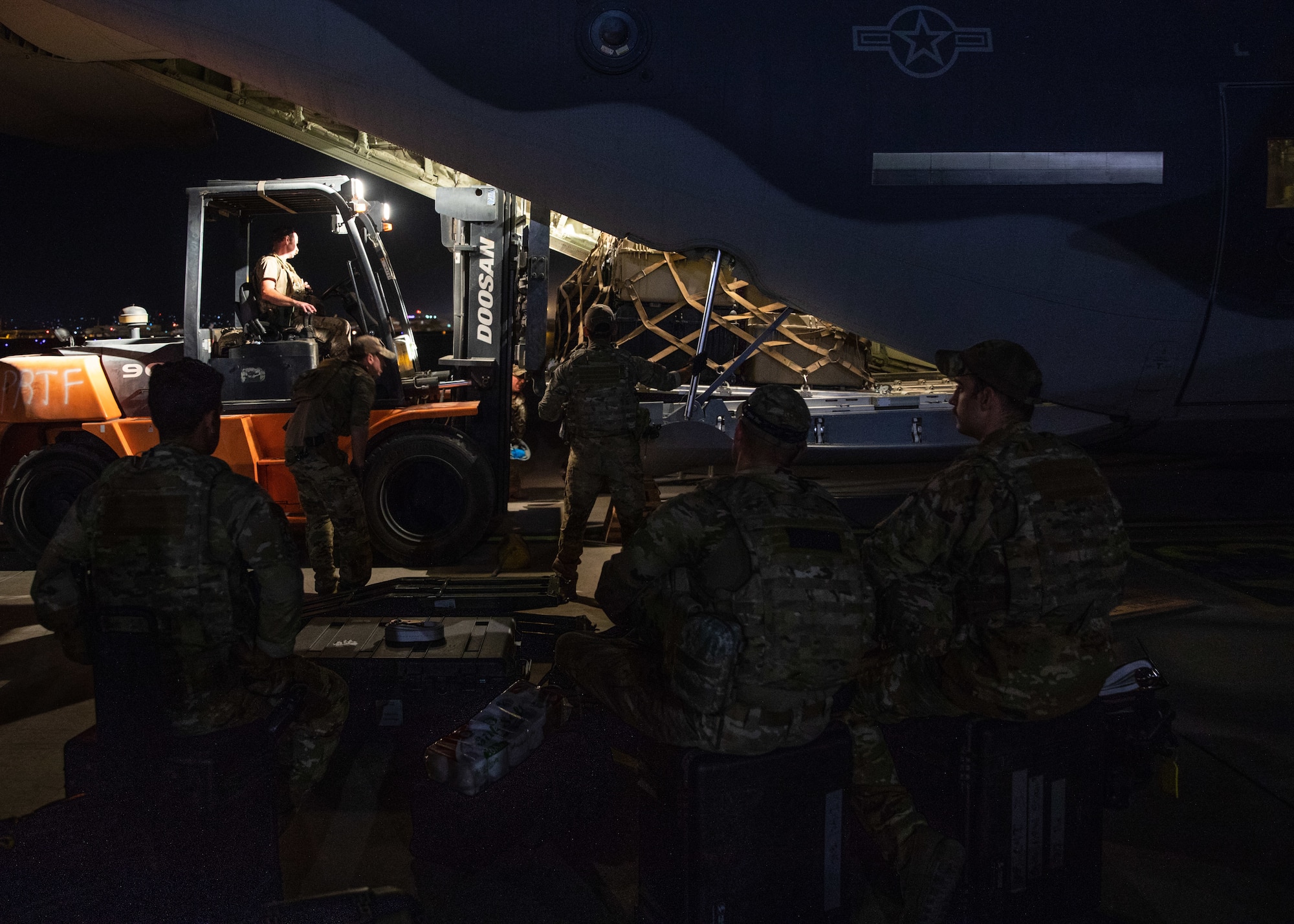 Airmen load cargo