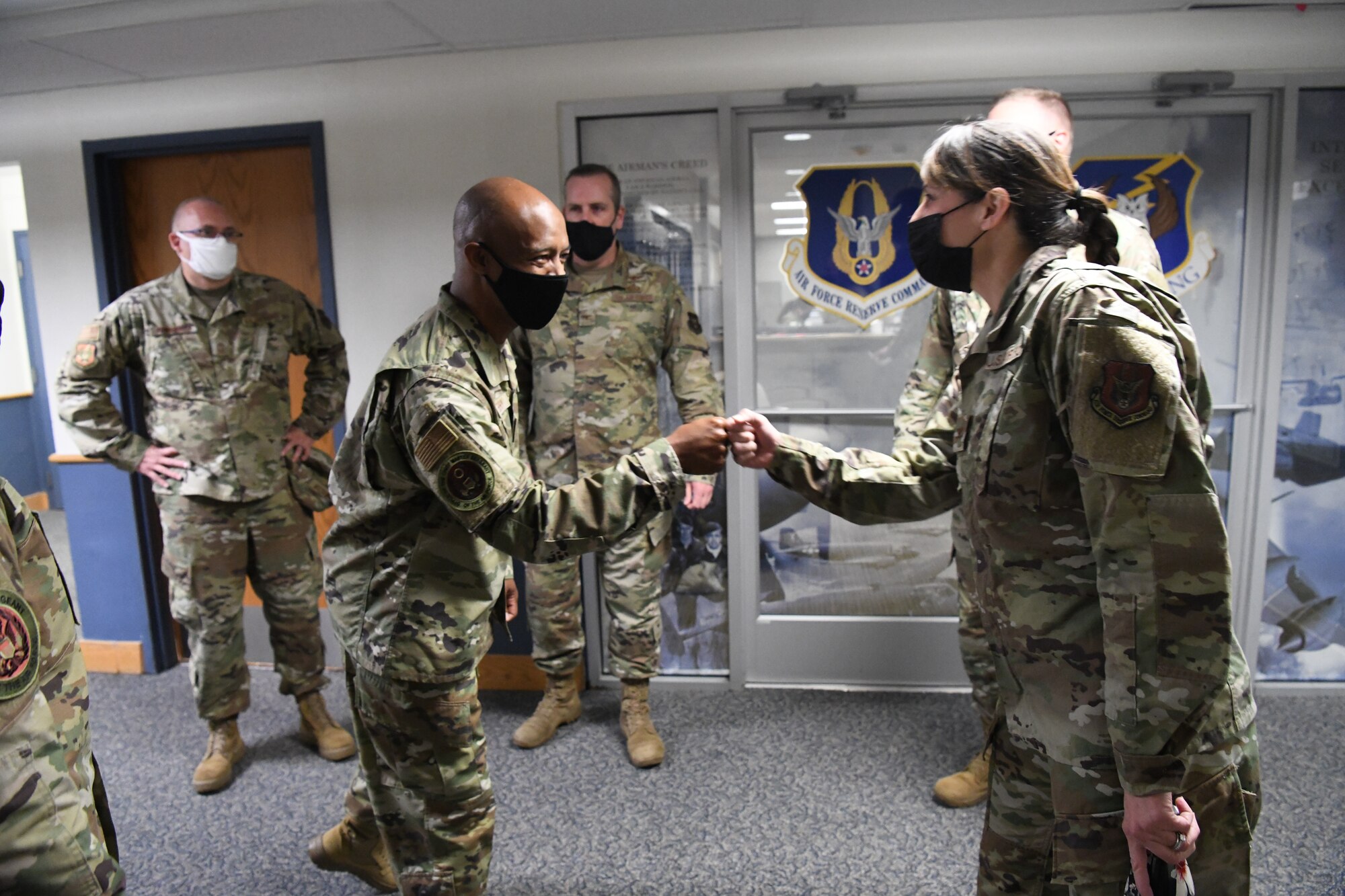 Chief Master Sgt. Nathaniel Perry, Air Force first sergeant special duty manager, fist bumps Chief Master Sgt. Elizabeth Robinson, 49th Intelligence Squadron/655th Intelligence, Surveillance and Reconnaissance Group senior enlisted leader, during Chief Master Sgt. of the Air Force JoAnne Bass and her team’s visit to the 655th ISR Wing Oct. 2, 2021. While at the wing, Bass received a 655th ISR Wing overview briefing and participated in an enlisted call where she coined Tech. Sgt. Jana Palant, 655th ISR Group NCO in charge of readiness and training for being an exceptional performer in her unit.