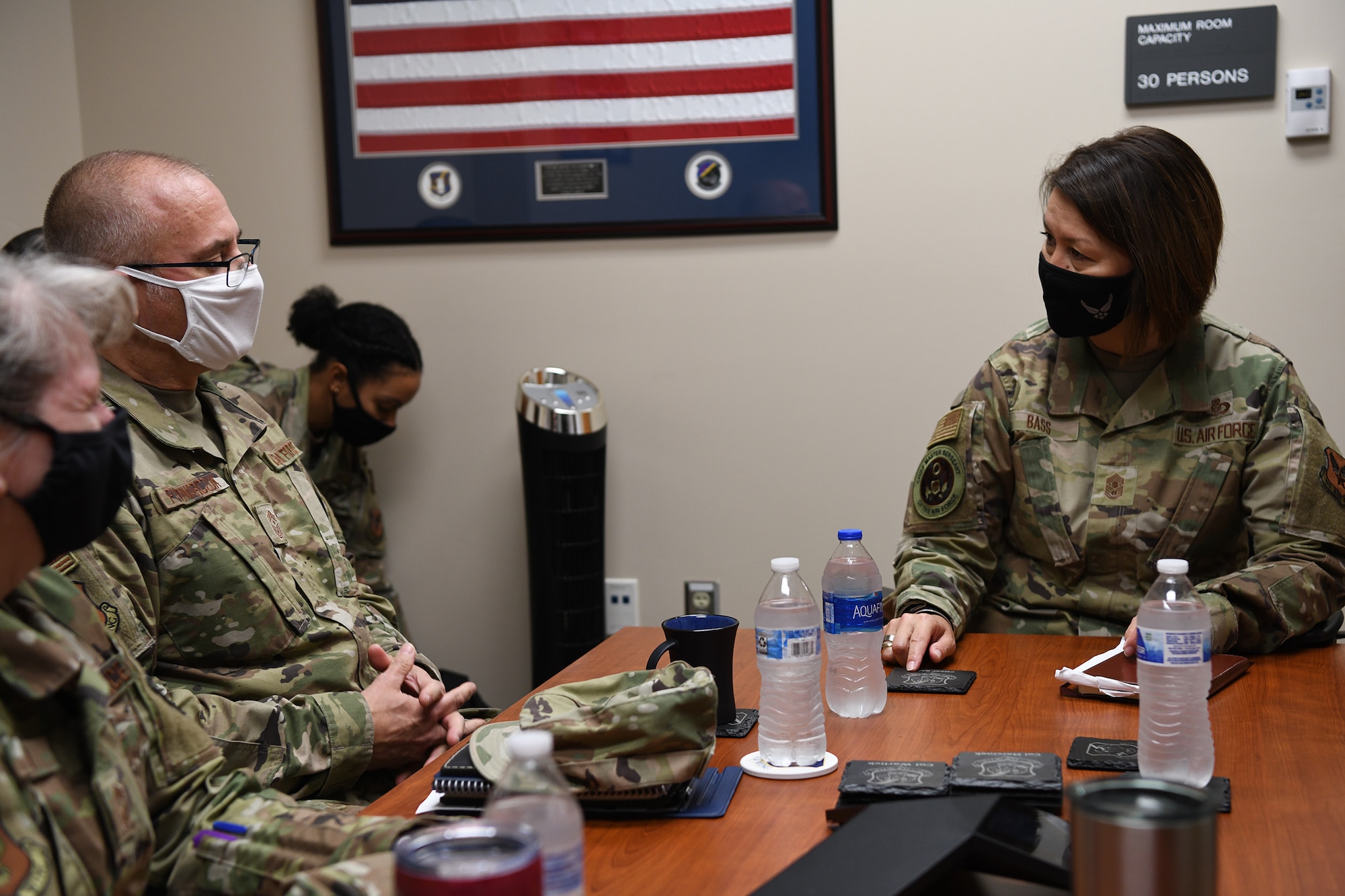 Chief Master Sgt. Bohdan Pywowarczuk, II, 655th Intelligence, Surveillance and Reconnaissance Wing command chief, and Chief Master Sgt. Jeannette Roman, 655th ISR Wing command chief liaison, give a 655th ISR Wing overview briefing to Chief Master Sgt. of the Air Force JoAnne Bass and her team Oct. 2, 2021. During her visit at the 655th, Bass participated in an enlisted call and coined their outstanding performer, Tech. Sgt. Jana Palant, 655th Intelligence, Surveillance and Reconnaissance Group NCO in charge of readiness and training.