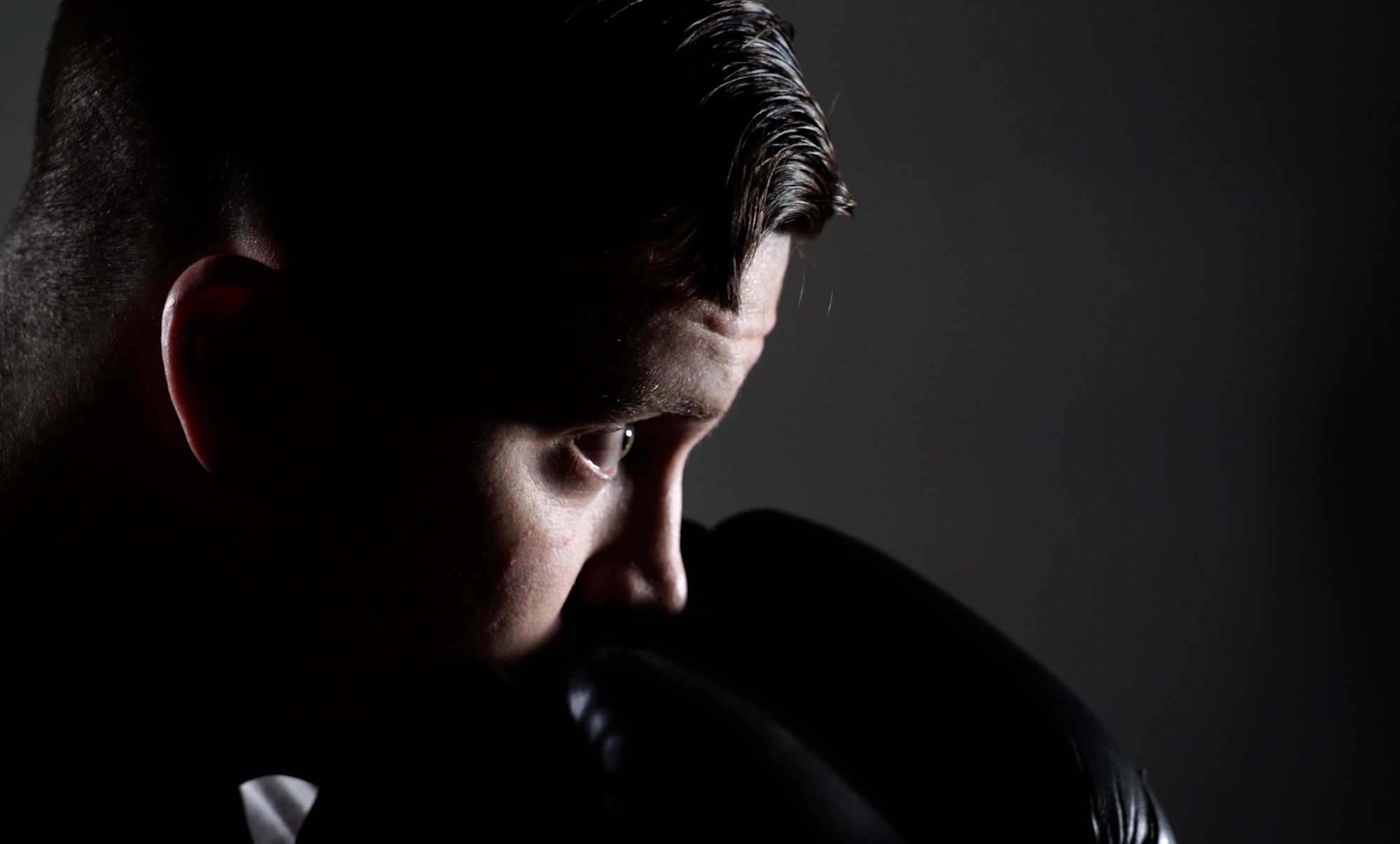 Staff Sgt. Jonathan Cornelius, Base Defense Operations Center controller assigned to the 319th Security Forces Squadron, prepares to strike a punching bag on Grand Forks Air Force Base, N.D., Mar. 22, 2021. A profession of arms requires Airmen to integrate fitness into their daily routines to ensure the success of the mission. (U.S. Air Force photo by Airman 1st Class Jack LeGrand)