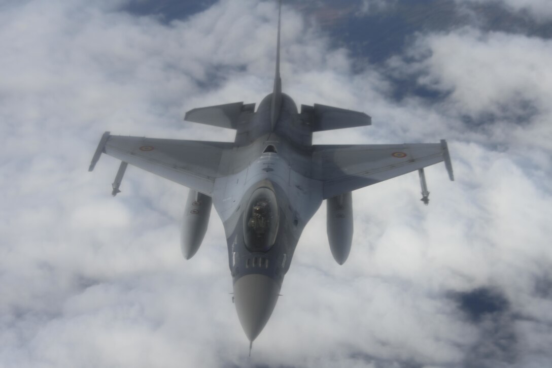 A Romanian air force F-16 Fighting Falcon aircraft drops back from a U.S. Air Force KC-135 Stratotanker aircraft assigned to the 100th Air Refueling Wing, Royal Air Force Mildenhall, England, after receiving fuel over Romania, Oct. 7, 2021. The 100th ARW is the only permanent U.S. air refueling wing in Europe and Africa. (U.S. Air Force photo by Senior Airman Joseph Barron)