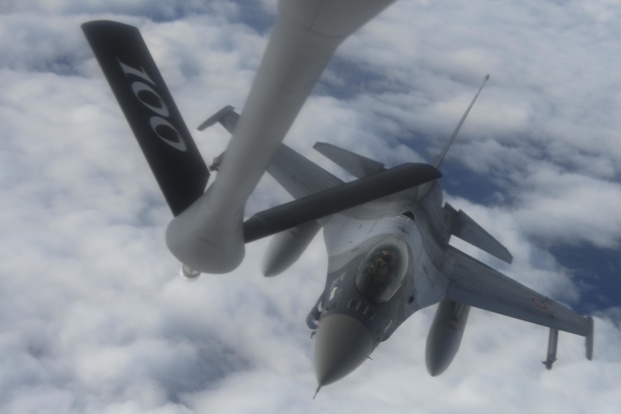 A Romanian air force F-16 Fighting Falcon aircraft approaches a U.S. Air Force KC-135 Stratotanker aircraft assigned to the 100th Air Refueling Wing, Royal Air Force Mildenhall, England, to receive fuel over Romania Oct. 7, 2021. The 100th ARW is the only permanent U.S. air refueling wing in the European theater, providing the critical air refueling "bridge" which allows the expeditionary Air Force to deploy around the globe at a moment's notice. (U.S. Air Force photo by Senior Airman Joseph Barron)