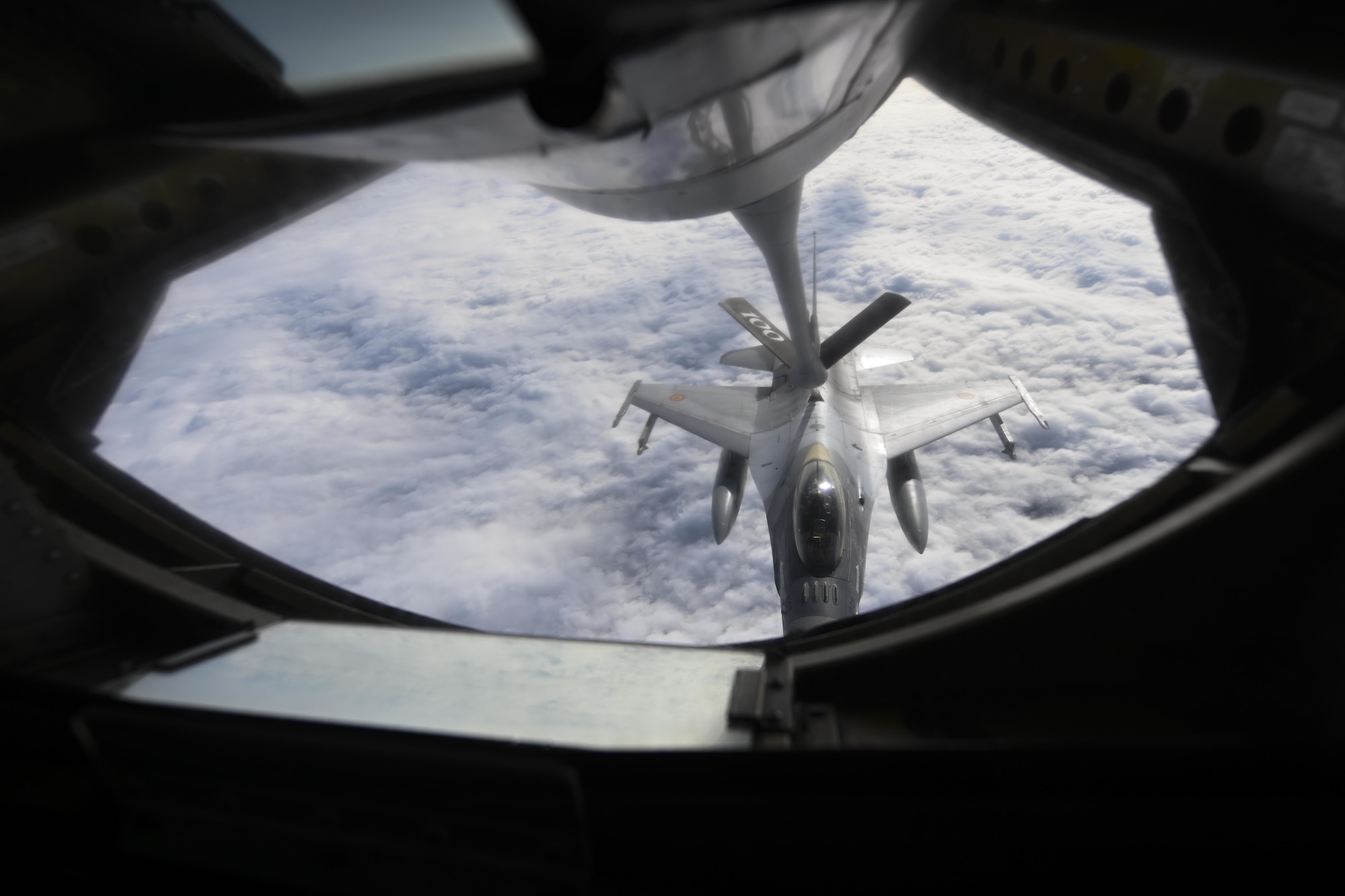 A Romanian air force F-16 Fighting Falcon aircraft receives fuel over Romania from a U.S. Air Force KC-135 Stratotanker aircraft assigned to the 100th Air Refueling Wing, Royal Air Force Mildenhall, England, Oct. 7, 2021. The 100th ARW supports the Air Force's global reach mission by extending the range of U.S. Air Force aircraft in Europe and Africa. (U.S. Air Force photo by Senior Airman Joseph Barron)