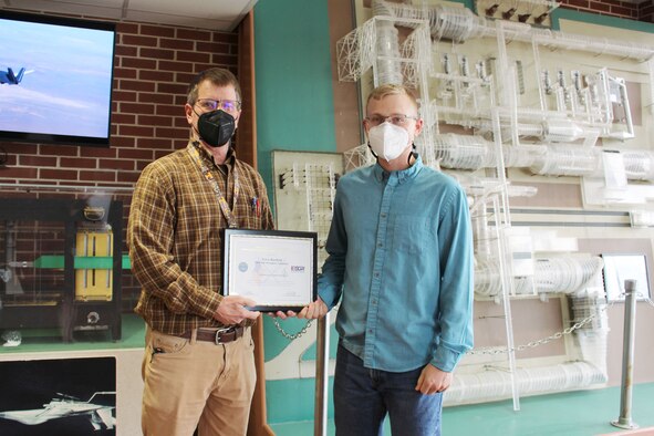 From left, Terry Rayfield accepts a plaque Oct. 5, 2021, at Arnold Air Force Base, Tenn., from Andy Grissom, who nominated Rayfield for the Extraordinary Employer Support Award through the Employer Support of Guard and Reserve, or ESGR, program. ESGR is a Department of Defense program established in 1972 to promote cooperation and understanding between Reserve Component Service members and their civilian employers. (U.S. Air Force photos by Deidre Moon)