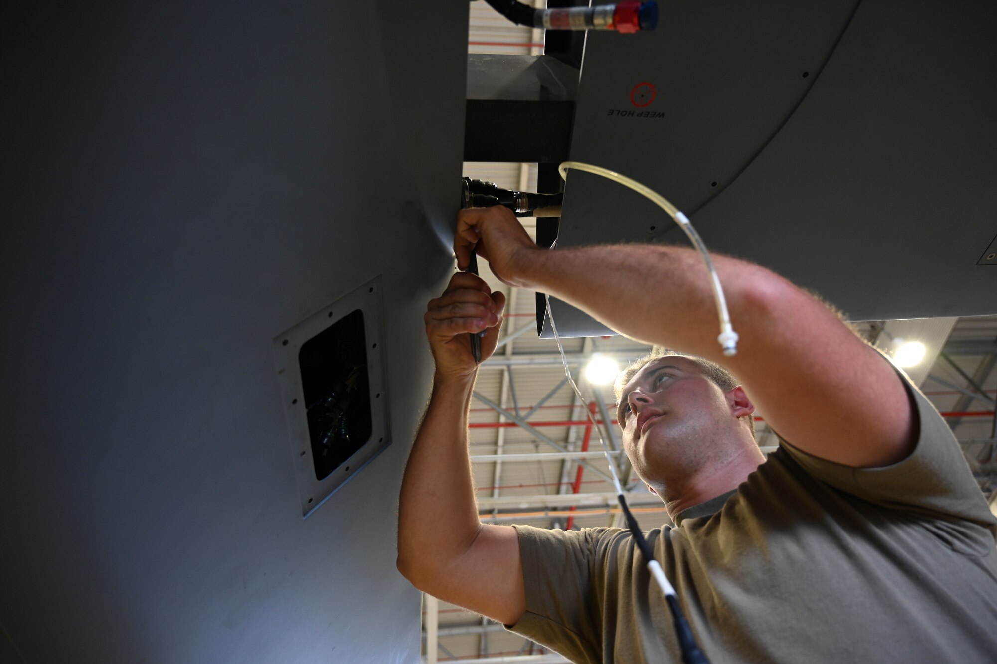 Staff Sgt. Lucas Jesuit, 49th Aircraft Maintenance Squadron dedicated crew chief, attaches a wing to an MQ-9 Reaper Sept. 12, 2021, on Marine Corps Base Hawaii. This joint exercise is designed to sharpen combat readiness, increase strategic impact, and strengthen deterrence efforts by ensuring tactical proficiency of MQ-9 aircrews. (U.S. Air Force photo by Airman 1st Class Adrian Salazar)