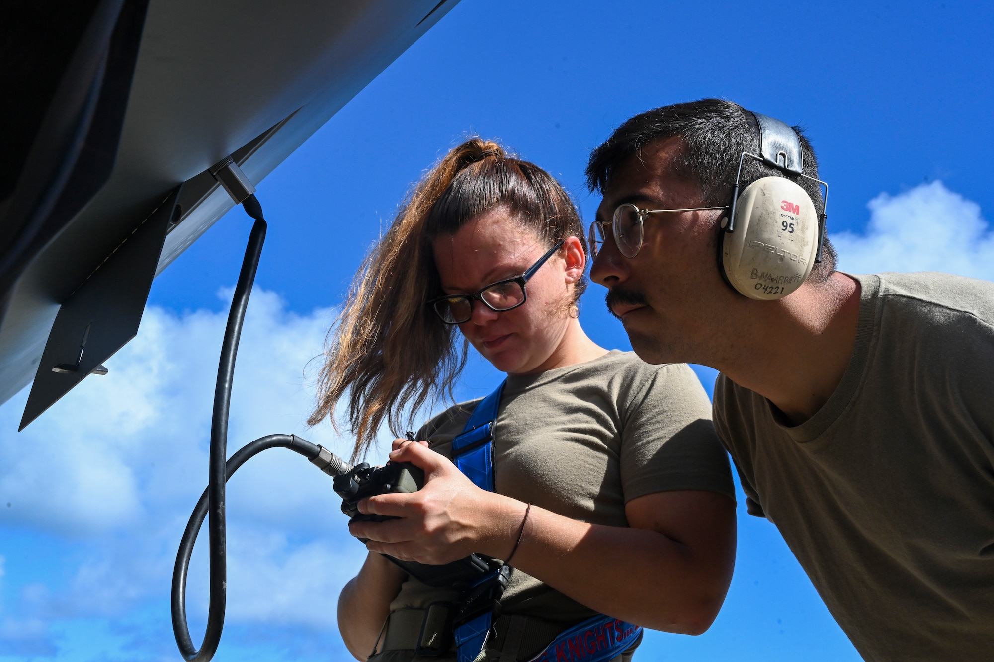 Staff Sgt. Aubree Kovalick, 49th Aircraft Maintenance Squadron avionics technician, and Airman 1st Class Brandon Navarrete, 49th AMXS special avionics technician, load GPS keys to an MQ-9 Reaper Sept. 15, 2021, on Marine Corps Base Hawaii. The purpose of Exercise Agile Combat Employment Reaper is to demonstrate the MQ-9 assets and the ability to rapidly mobilize and integrate across multiple domains. (U.S. Air Force photo by Airman 1st Class Adrian Salazar)