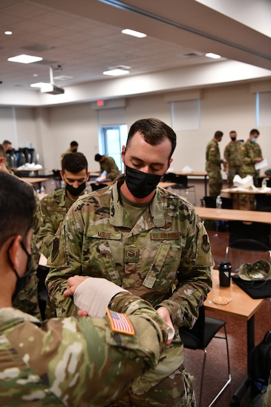 Staff Sgt. Griffin Moore, 104th Operations Group intel analyst, displays his medical skills during the German Armed Forces Proficiency Badge event Sept. 9, 2021, at Hanscom Air Force Base, Massachusetts. Participants in the event were tested over a three-day period on swimming, a ruck march, marksmanship, a fitness assessment, and more. (U.S. Air National Guard photo by Randy Burlingame)