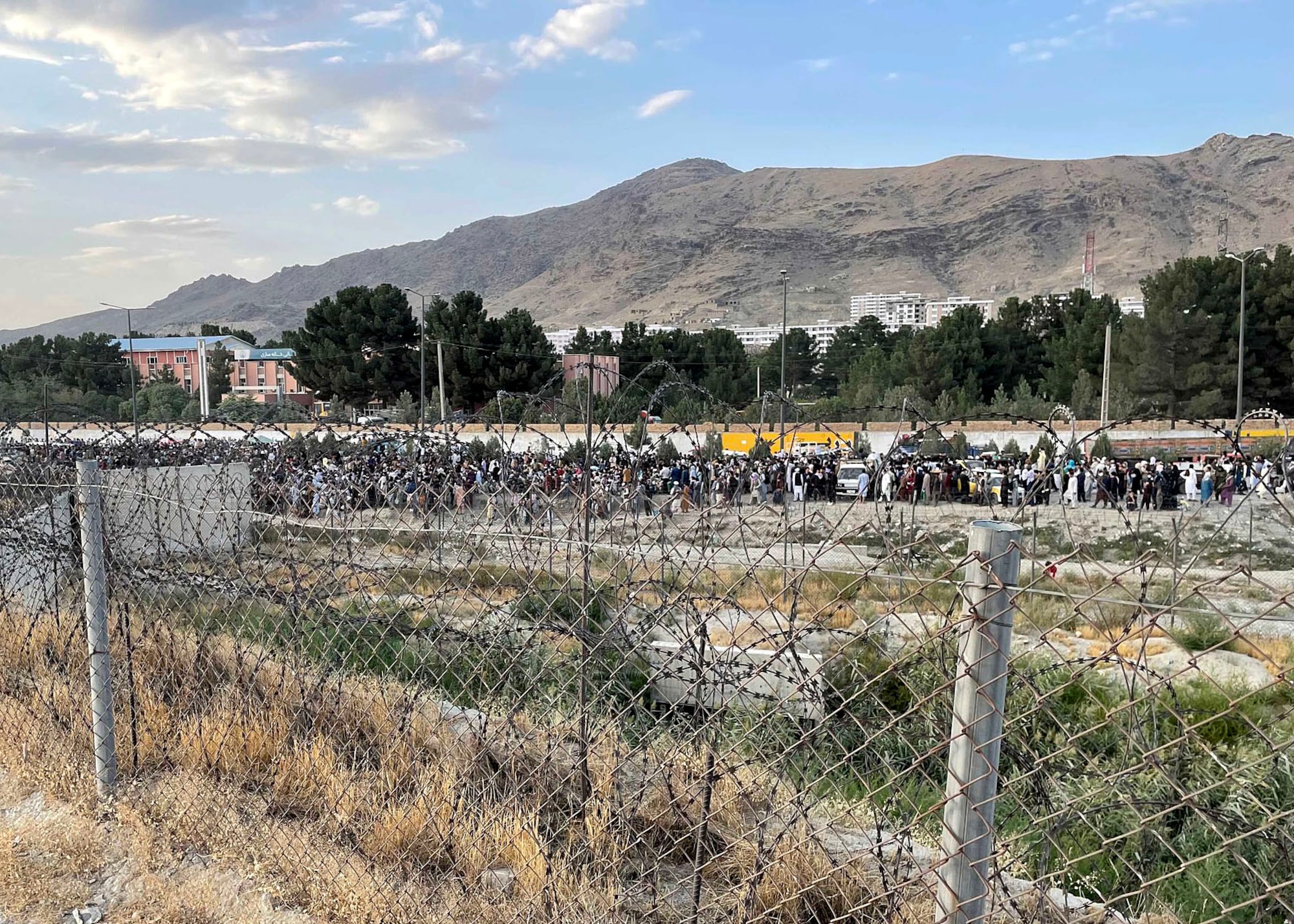 Afghan evacuees stand in line