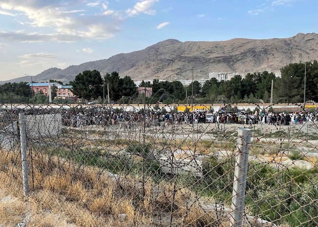 Afghan evacuees stand in line