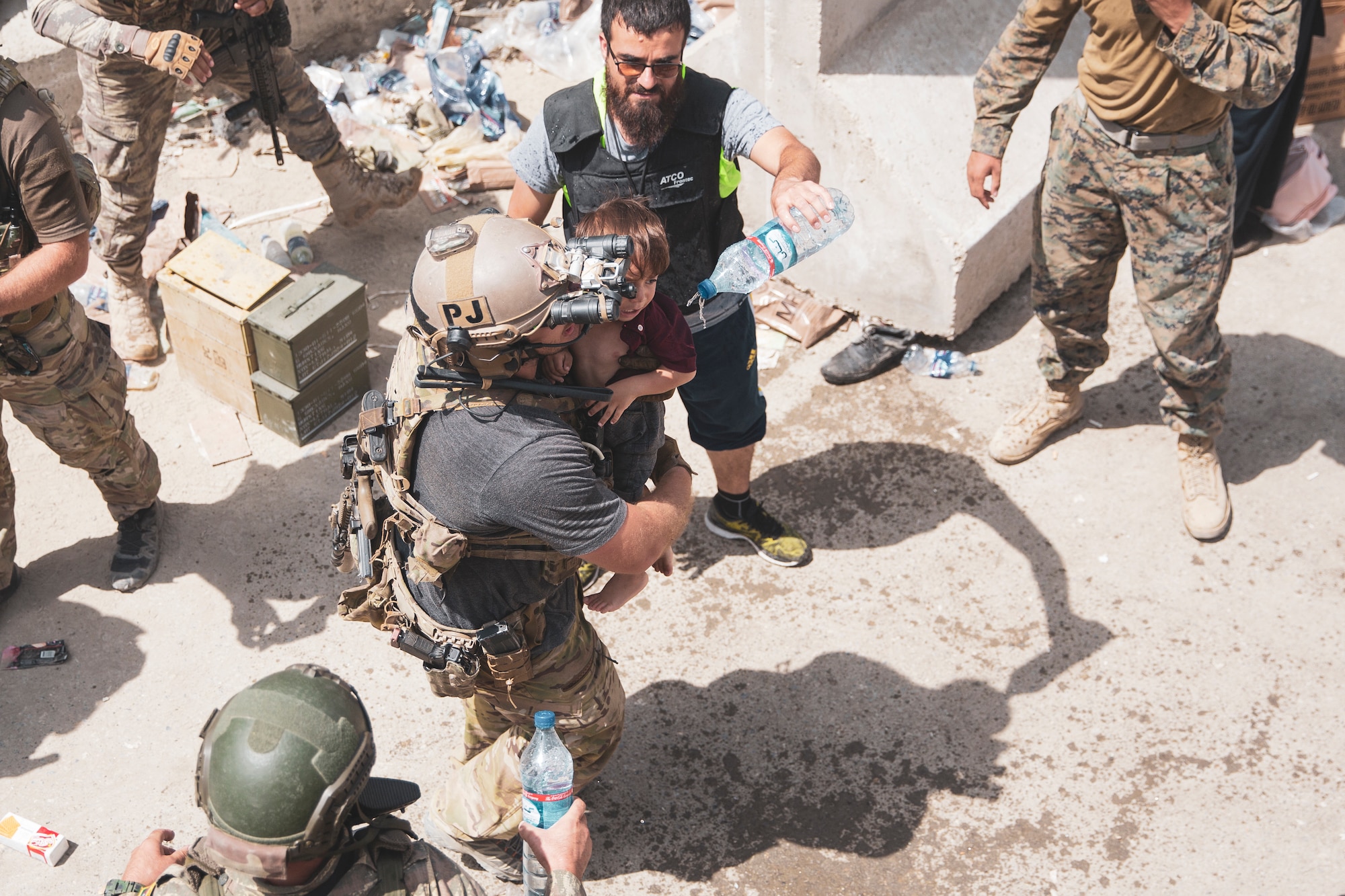 An Airman carries a child