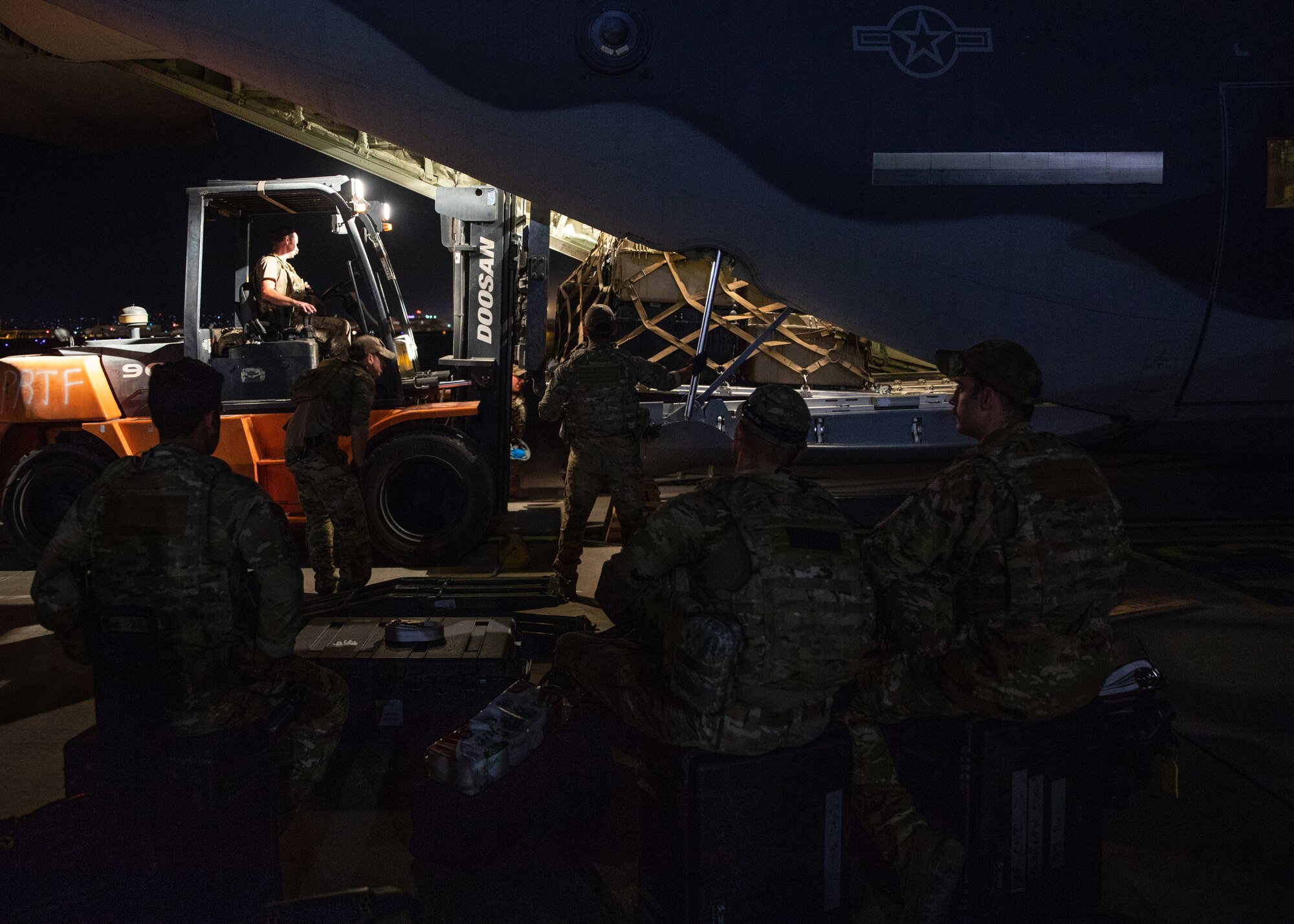 Airmen load cargo