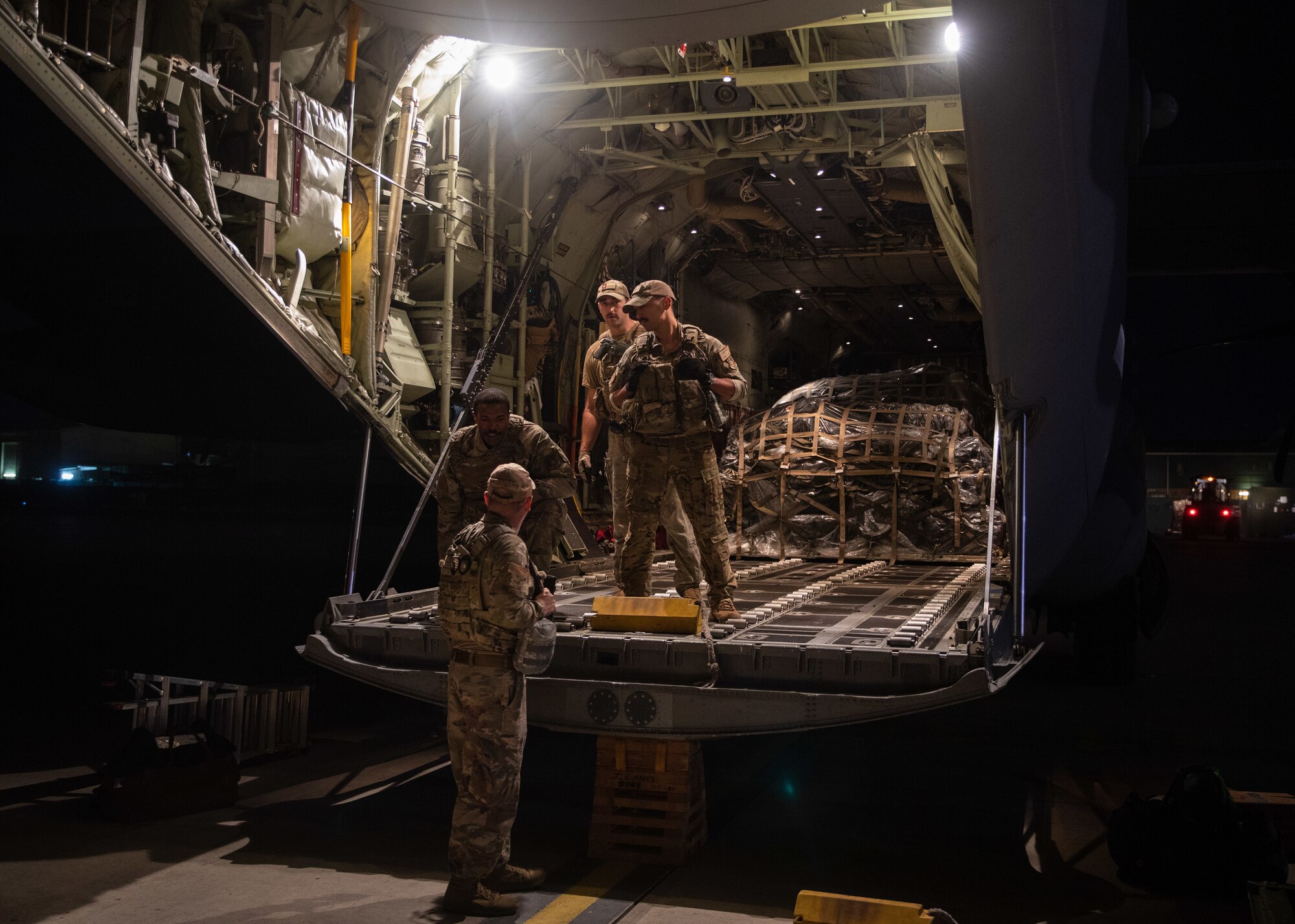 Airmen load cargo