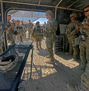 Maj. Gen. Dennis P. LeMaster receiving a briefing while at the National Training Center, Fort Irwin, California.