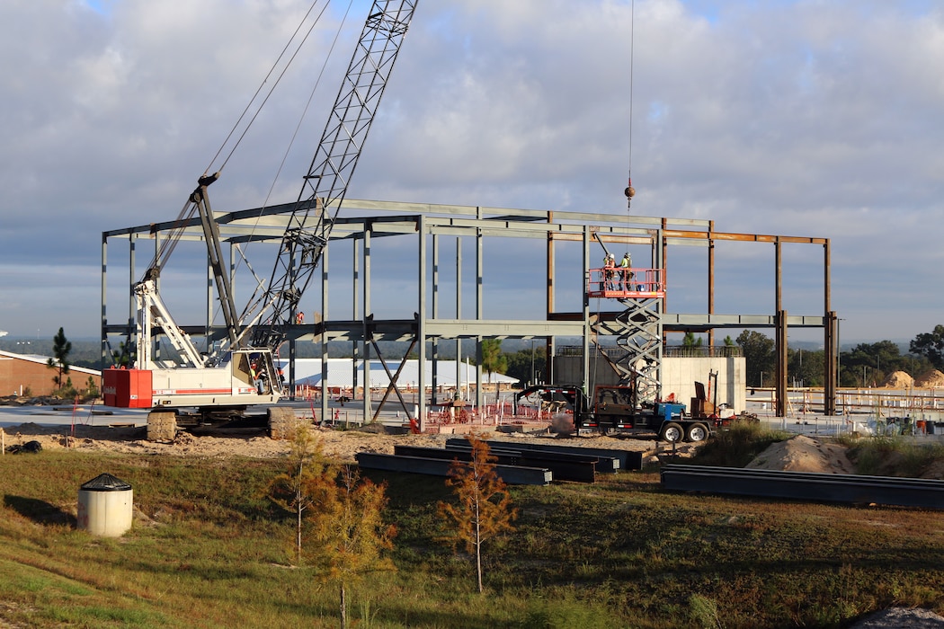 Workers put in a structural steel frame for a company-sized barracks at Fort Jackson, South Carolina as part of the Basic Training Complex Four, Phase Two project.  Formally known as a Basic Combat Trainee Complex, it has all the required facilities to house and fully train the Army’s new recruits, while also being close to field training areas and ranges.  The project has a current cost of about $42 million and is expected to be finished at the end of 2022.