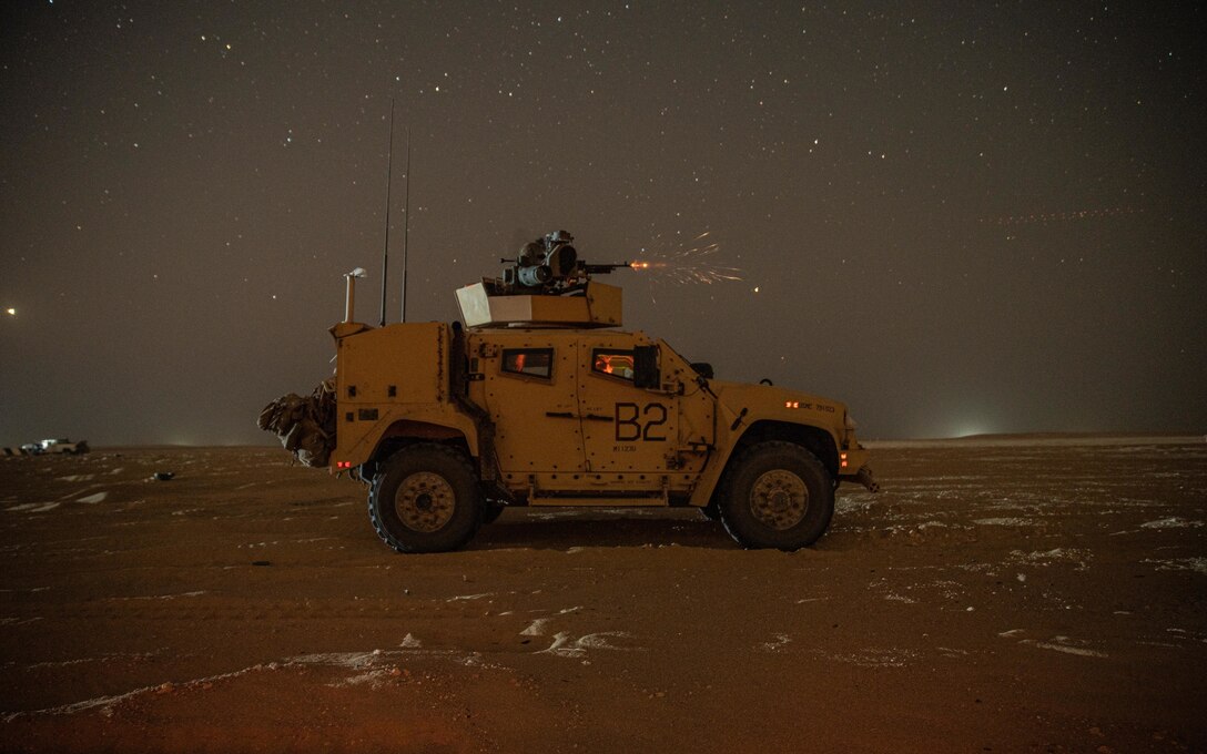 Marines assigned to Weapons Company, Battalion Landing Team 1/1, 11th Marine Expeditionary Unit, fire an M240B mounted on a Joint Light Tactical Vehicle during a live-fire range at Camp Buehring, Kuwait, Oct. 7, 2021. The 11th MEU and Essex Amphibious Ready Group are deployed to the U.S. 5th Fleet area of operations in support of naval operations to ensure maritime stability and security in the Central Region, connecting the Mediterranean and Pacific through the Western Indian Ocean and three strategic choke points.