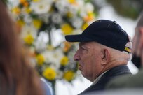 NAVAL STATION NORFOLK (Oct. 12, 2021) Retired Master Chief Sonar Technician Paul Abney, a USS Cole survivor, watches a prerecorded USS Cole Remembrance Ceremony at the USS Cole Memorial. Cole friends, family and shipmates gathered on board Naval Station Norfolk for the 21st remembrance of the USS Cole terrorist attack. Seventeen Sailors lost their lives and another 39 sustained injuries while the crew worked for 96 consecutive hours to keep the ship afloat. (U.S. Navy photo by Mass Communication Specialist 1st Class Jacob Milham)