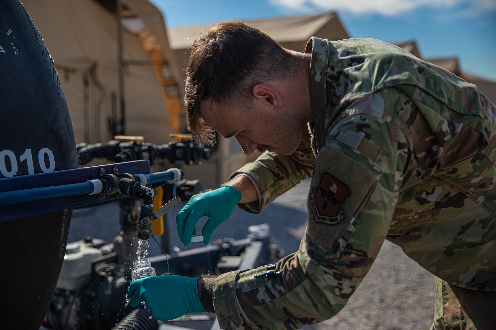 Senior Airman Ethan Dennis, a bioenvironmental engineer attached to Task Force Holloman, tests the water on Holloman Air Force Base, New Mexico, Oct. 7, 2021. The Department of Defense, through U.S. Northern Command, and in support of the Department of Homeland Security, is providing transportation, temporary housing, medical screening, and general support for at least 50,000 Afghan evacuees at suitable facilities, in permanent or temporary structures, as quickly as possible. This initiative provides Afghan personnel essential support at secure locations outside Afghanistan. (U.S. Army photo by Pfc. Anthony Sanchez)