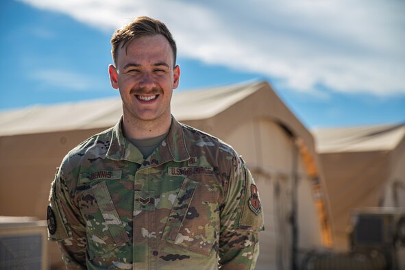 Senior Airman Ethan Dennis, a bioenvironmental engineer attached to Task Force Holloman, poses for a photo on Holloman Air Force Base, New Mexico, Oct. 7, 2021. The Department of Defense, through U.S. Northern Command, and in support of the Department of Homeland Security, is providing transportation, temporary housing, medical screening, and general support for at least 50,000 Afghan evacuees at suitable facilities, in permanent or temporary structures, as quickly as possible. This initiative provides Afghan personnel essential support at secure locations outside Afghanistan. (U.S. Army photo by Pfc. Anthony Sanchez)