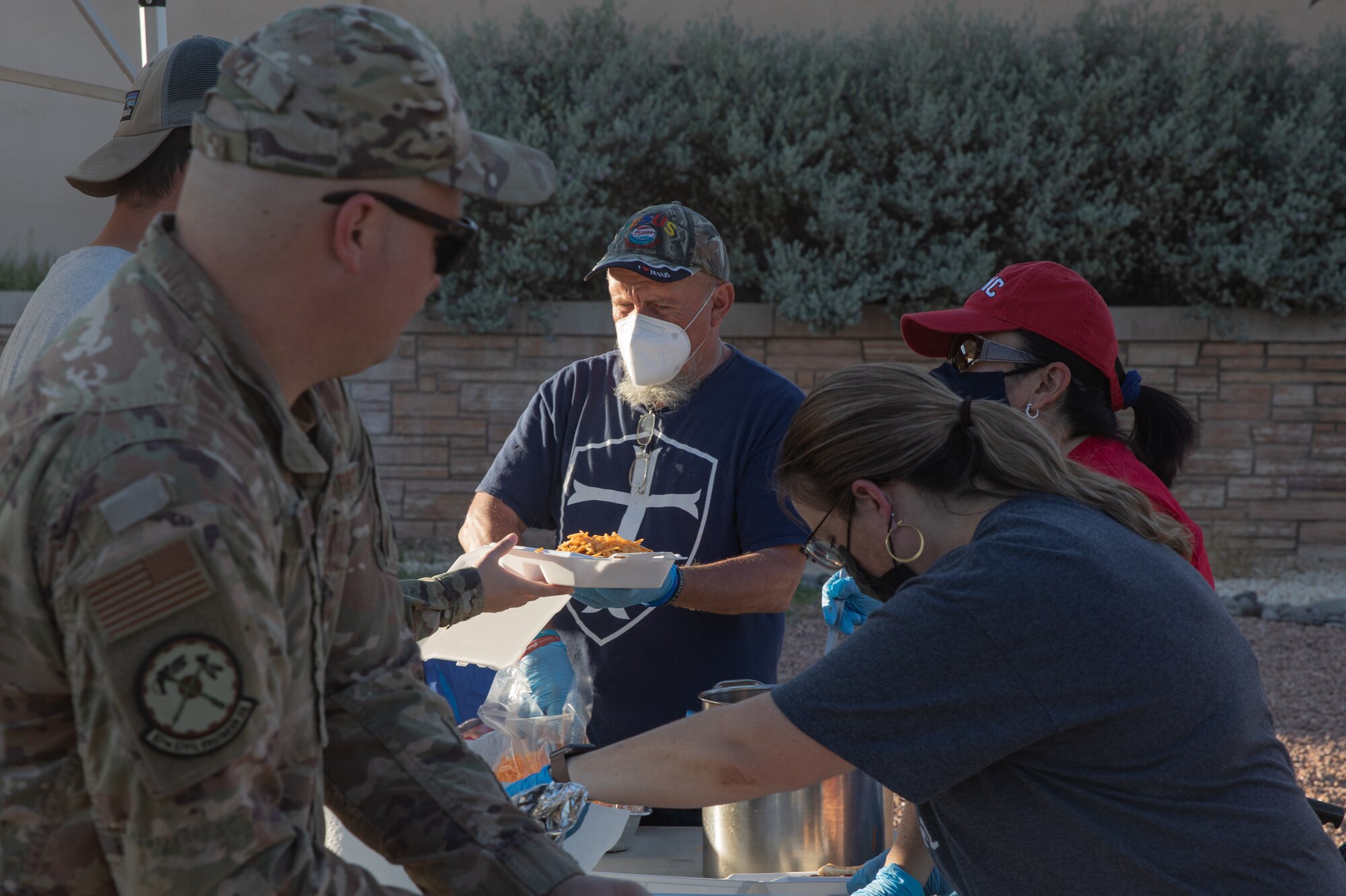 Volunteers from Mountain View Church hand out free meals to Task Force Holloman members at Holloman Air Force Base, New Mexico, Oct. 5, 2021. The Department of Defense, through the U.S. Northern Command, and in support of the Department of State and Department of Homeland Security, is providing transportation, temporary housing, medical screening, and general support for at least 50,000 Afghan evacuees at suitable facilities, in permanent or temporary structures, as quickly as possible. This initiative provides Afghan evacuees essential support at secure locations outside Afghanistan. (U.S. Army photo by Spc. Nicholas Goodman)