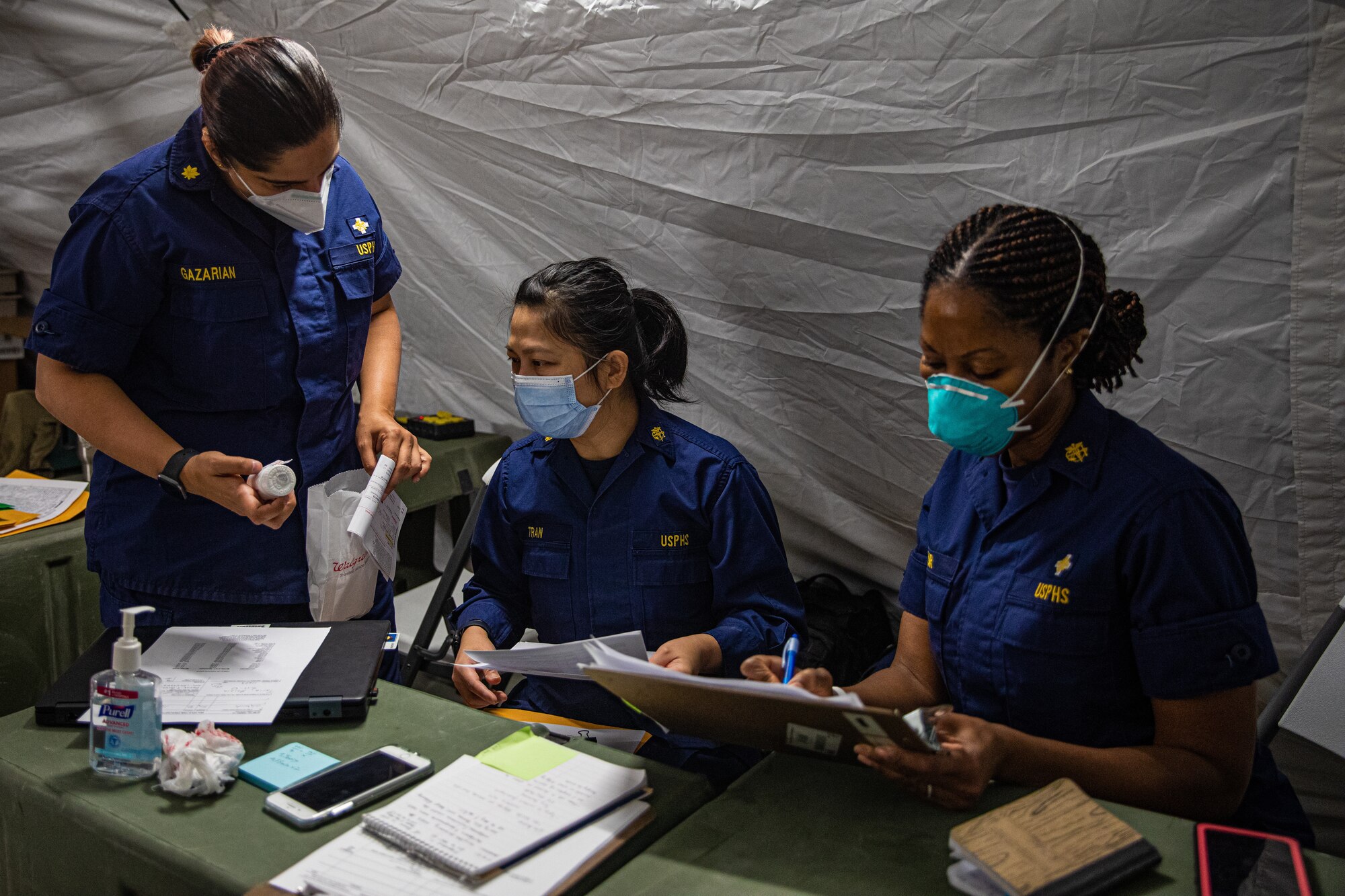 Personnel from the United States Public Health and Services Commissioned Corps, attached to Task Force Holloman, review medical records for Afghan evacuees on Holloman Air Force Base, New Mexico, Oct. 7, 2021. The Department of Defense, through U.S. Northern Command, and in support of the Department of Homeland Security, is providing transportation, temporary housing, medical screening, and general support for at least 50,000 Afghan evacuees at suitable facilities, in permanent or temporary structures, as quickly as possible. This initiative provides Afghan personnel essential support at secure locations outside Afghanistan. (U.S. Army photo by Pfc. Anthony Sanchez)
