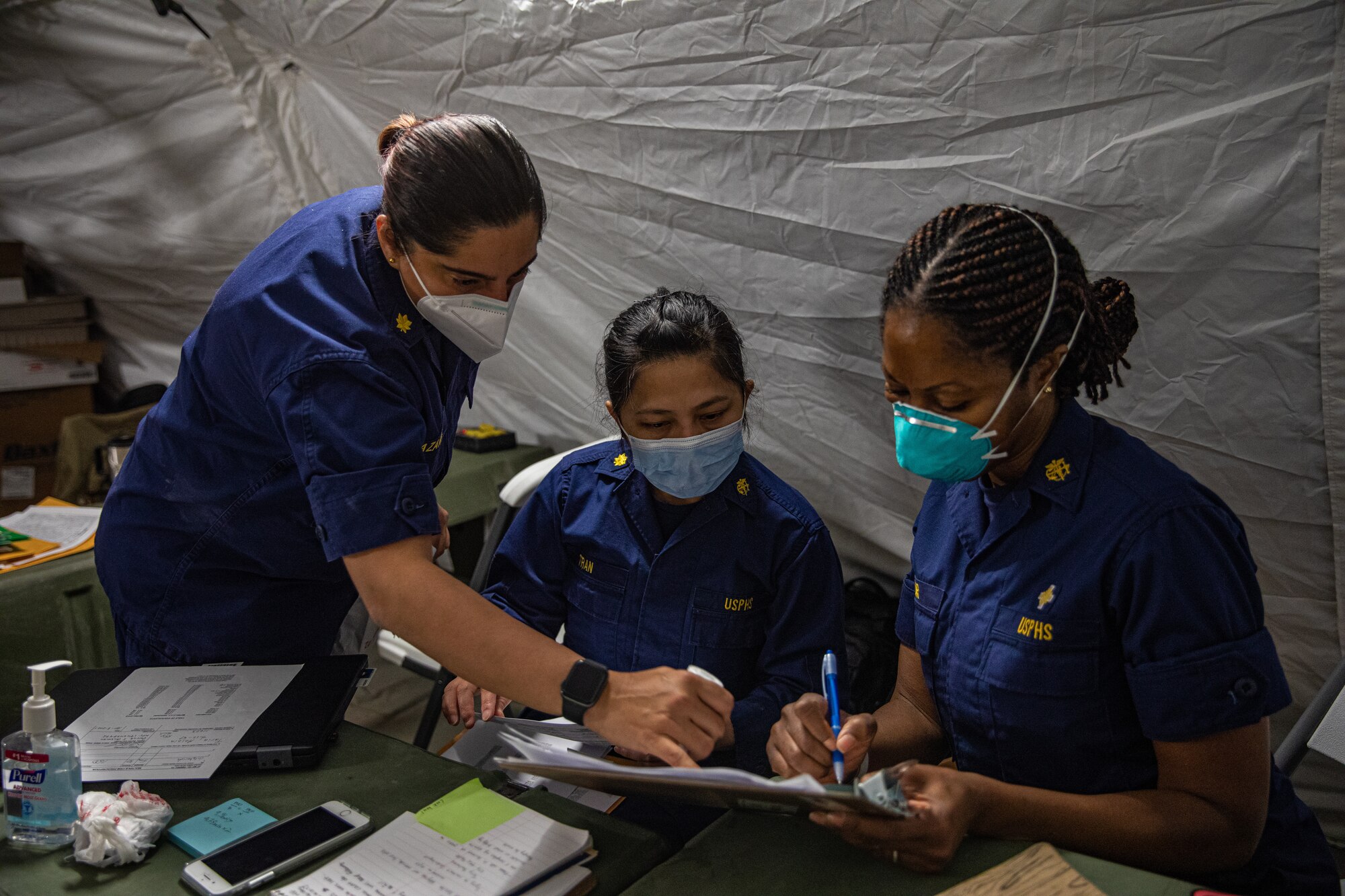 Personnel from the United States Public Health and Services Commissioned Corps, attached to Task Force Holloman, review medical records for Afghan evacuees on Holloman Air Force Base, New Mexico, Oct. 7, 2021. The Department of Defense, through U.S. Northern Command, and in support of the Department of Homeland Security, is providing transportation, temporary housing, medical screening, and general support for at least 50,000 Afghan evacuees at suitable facilities, in permanent or temporary structures, as quickly as possible. This initiative provides Afghan personnel essential support at secure locations outside Afghanistan. (U.S. Army photo by Pfc. Anthony Sanchez)