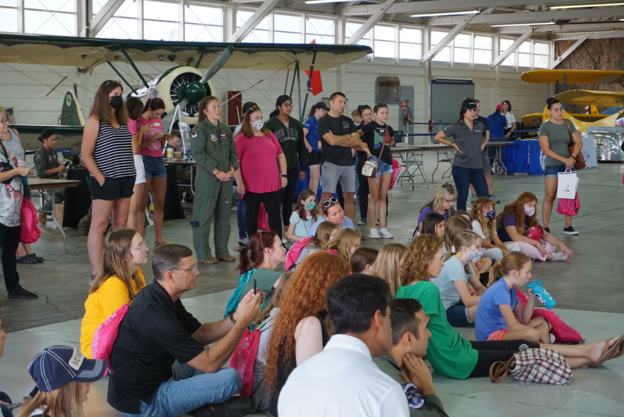 A photo of a group of people listening to a presentation.