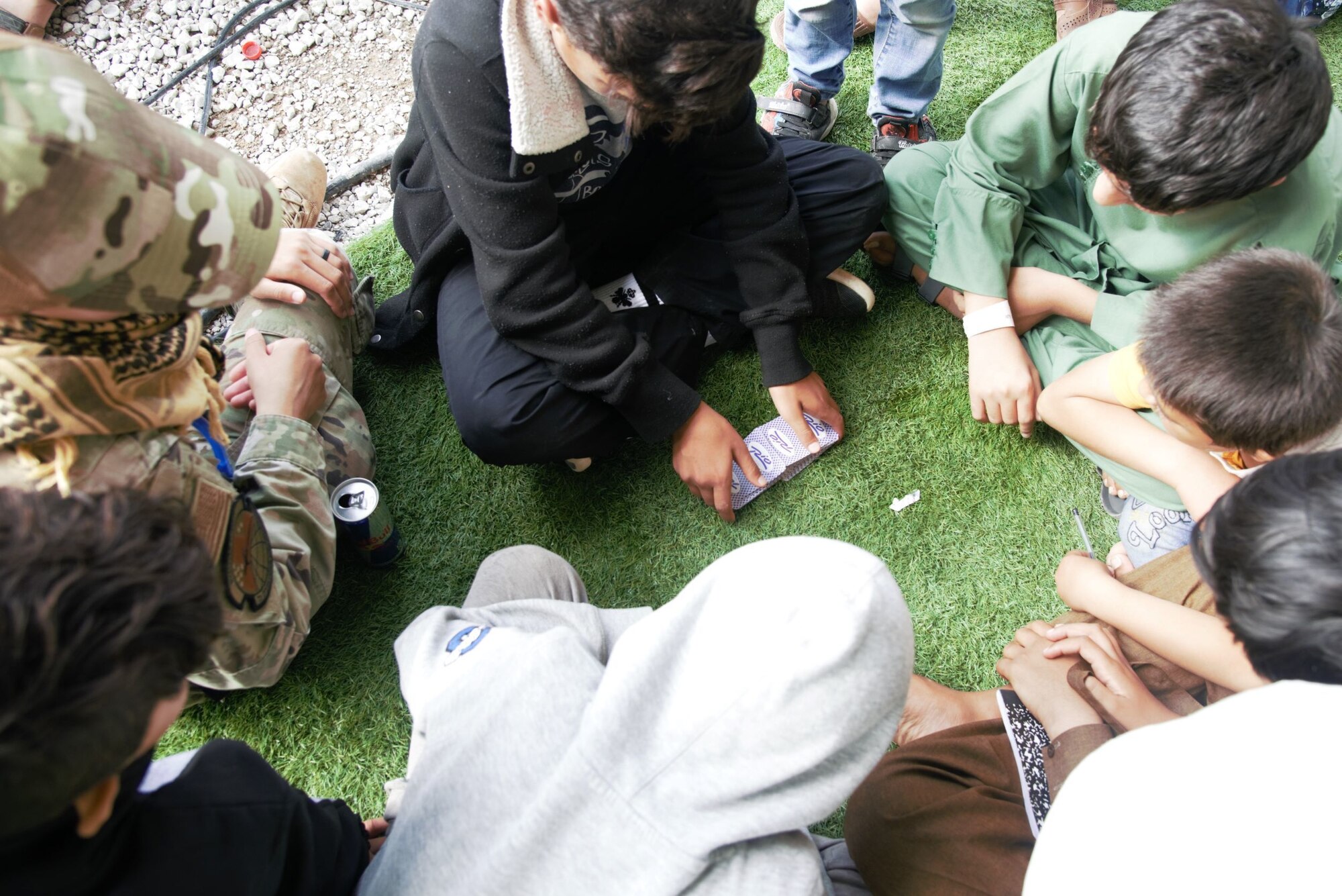An Afghan boy practices shuffling cards in Aman Omid Village on Holloman Air Force Base, New Mexico, Oct. 1, 2021. The Department of Defense, through U.S. Northern Command, and in support of the Department of State and Department of Homeland Security, is providing transportation, temporary housing, medical screening, and general support for at least 50,000 Afghan evacuees at suitable facilities, in permanent or temporary structures, as quickly as possible. This initiative provides Afghan evacuees essential support at secure locations outside Afghanistan. (U.S. Navy photo by Mass Communications Specialist 1st Class Sarah Rolin)