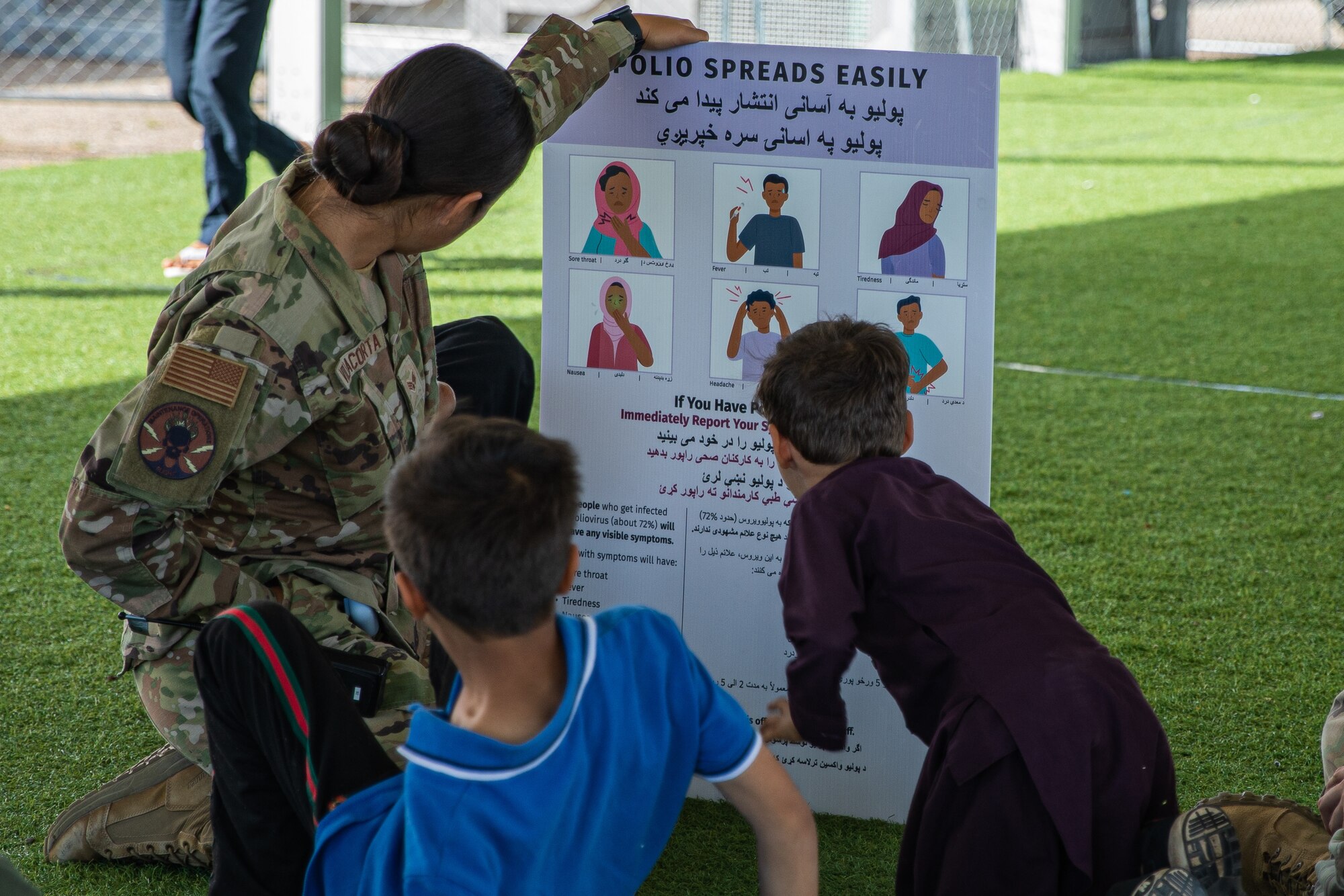 An Airman attached to Task Force-Holloman teaches Afghan children a lesson on public health precautions at Aman Omid Village on Holloman Air Force Base, New Mexico Oct. 07, 2021. The Department of Defense, through U.S. Northern Command, and in support of the Department of Homeland Security, is providing transportation, temporary housing, medical screening, and general support for at least 50,000 Afghan evacuees at suitable facilities, in permanent or temporary structures, as quickly as possible. This initiative provides Afghan personnel essential support at secure locations outside Afghanistan. (U.S. Army photo by Pfc. Anthony Sanchez)