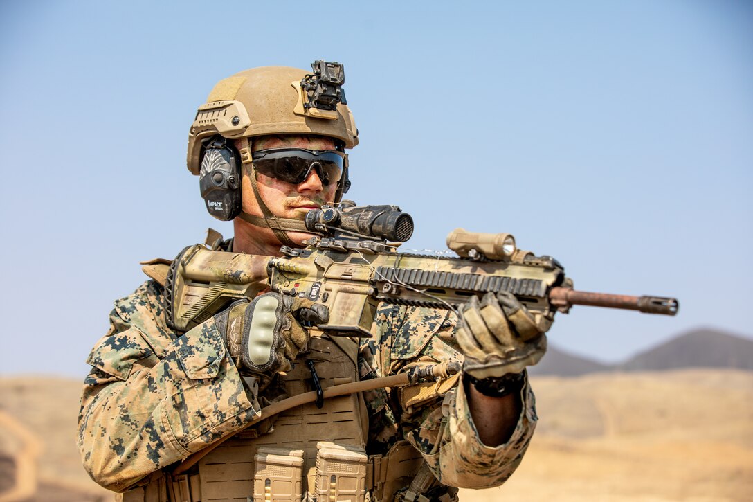 U.S. Marine Corps Lance Cpl. Brian R. Macarus, a rifleman with 3rd Battalion, 1st Marine Regiment, 1st Marine Division, looks down range during the Super Squad 21 competition on Range 800 at Marine Corps Base Camp Pendleton, California, Aug. 24, 2021. The Super Squad competition tests infantry squads in a variety of combat related skills and determines the most effective squad in the division. (U.S. Marine Corps photo by Lance Cpl. Quince Bisard)
