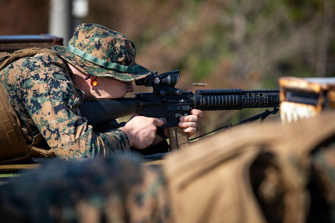 A U.S. Marine shoots down range at his target during the new Annual Rifle Qualification (ARQ) on Camp Hansen, Okinawa, Japan, Oct. 5, 2021. The ARQ is a three-day, combat-centric course of fire that tests Marines’ marksmanship skills in a dynamic-shooting environment. Shooters utilize artificial support, engage moving targets as well as engage targets while on the move. (U.S. Marine Corps photo by Cpl. Karis Mattingly)